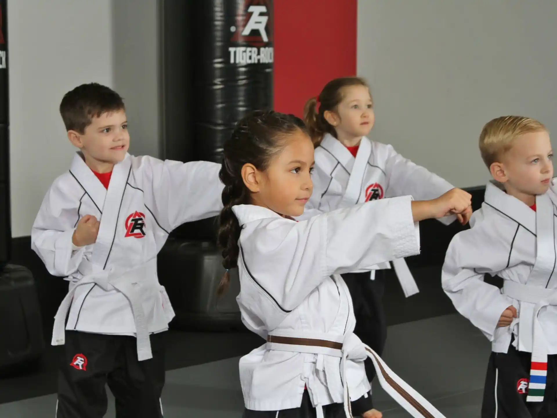 a group of children in karate uniforms