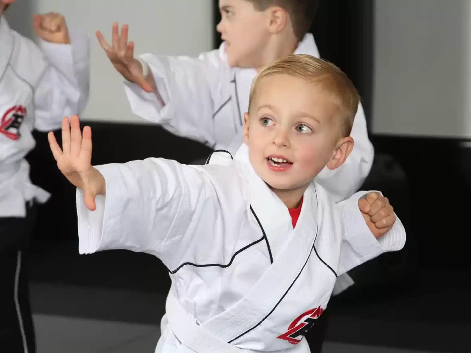 a young boy in a karate uniform
