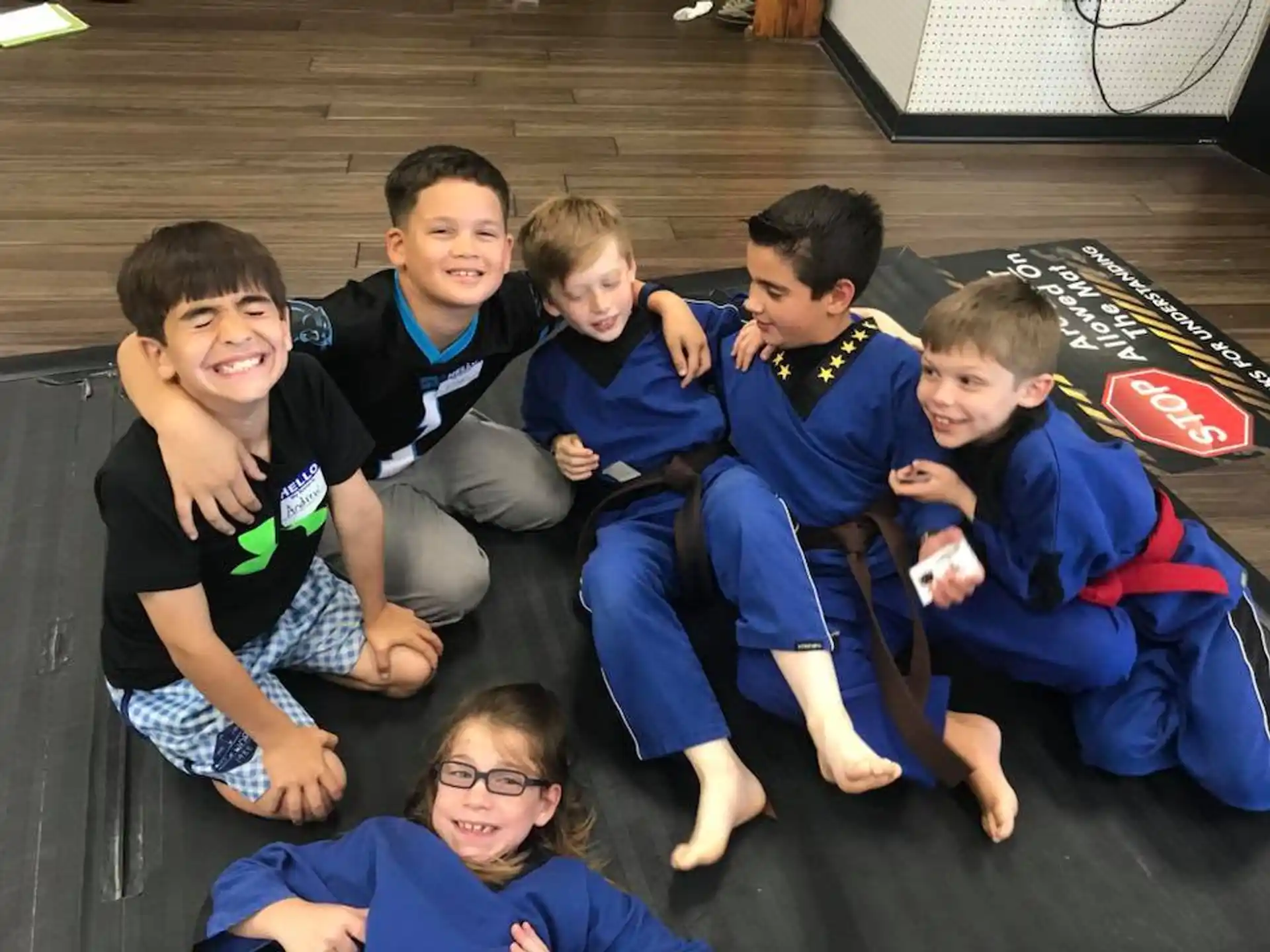 a group of kids sitting on the floor