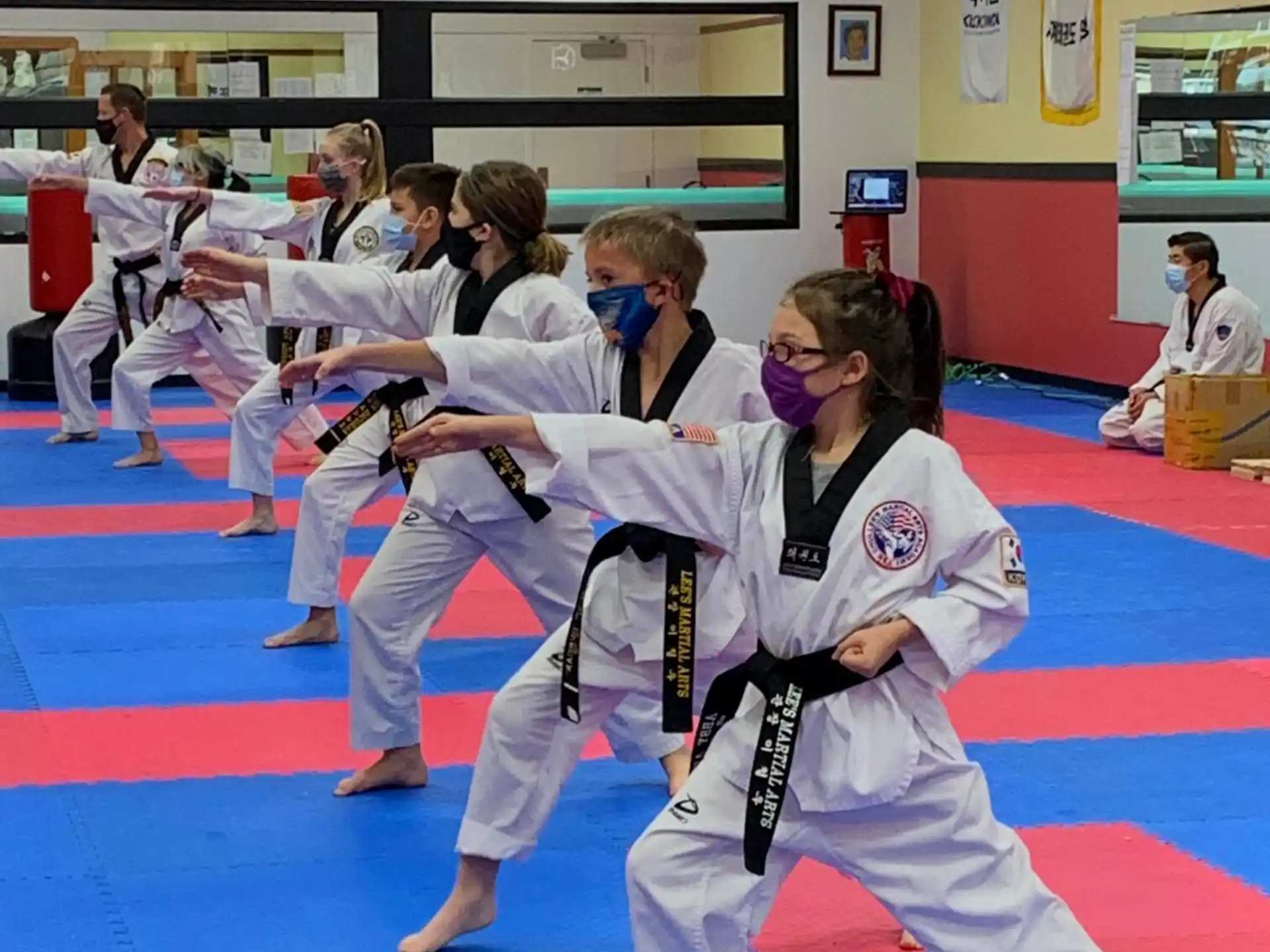 a group of people in karate uniforms