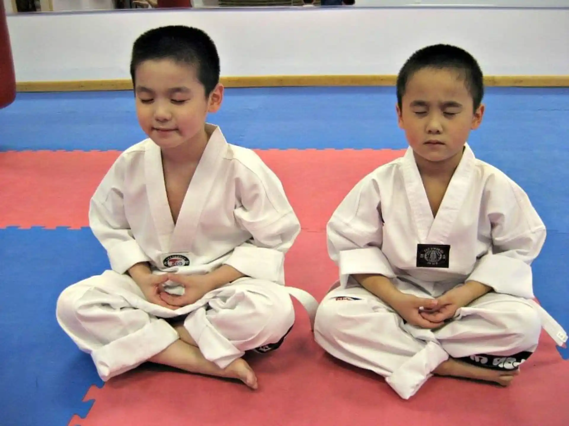 a couple of boys in karate uniforms