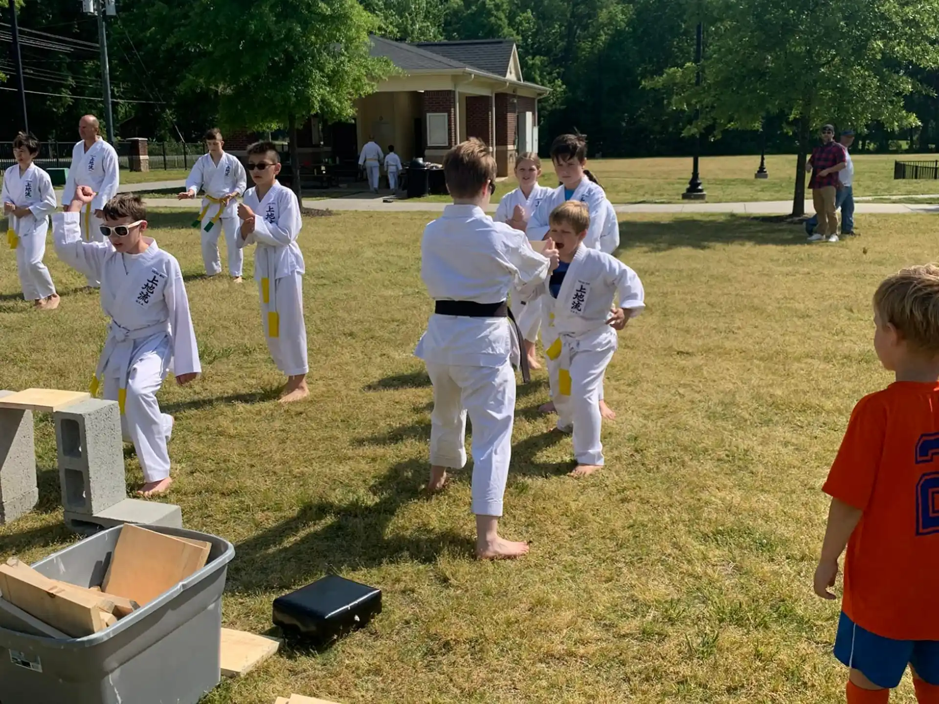 a group of people in white karate uniforms outside