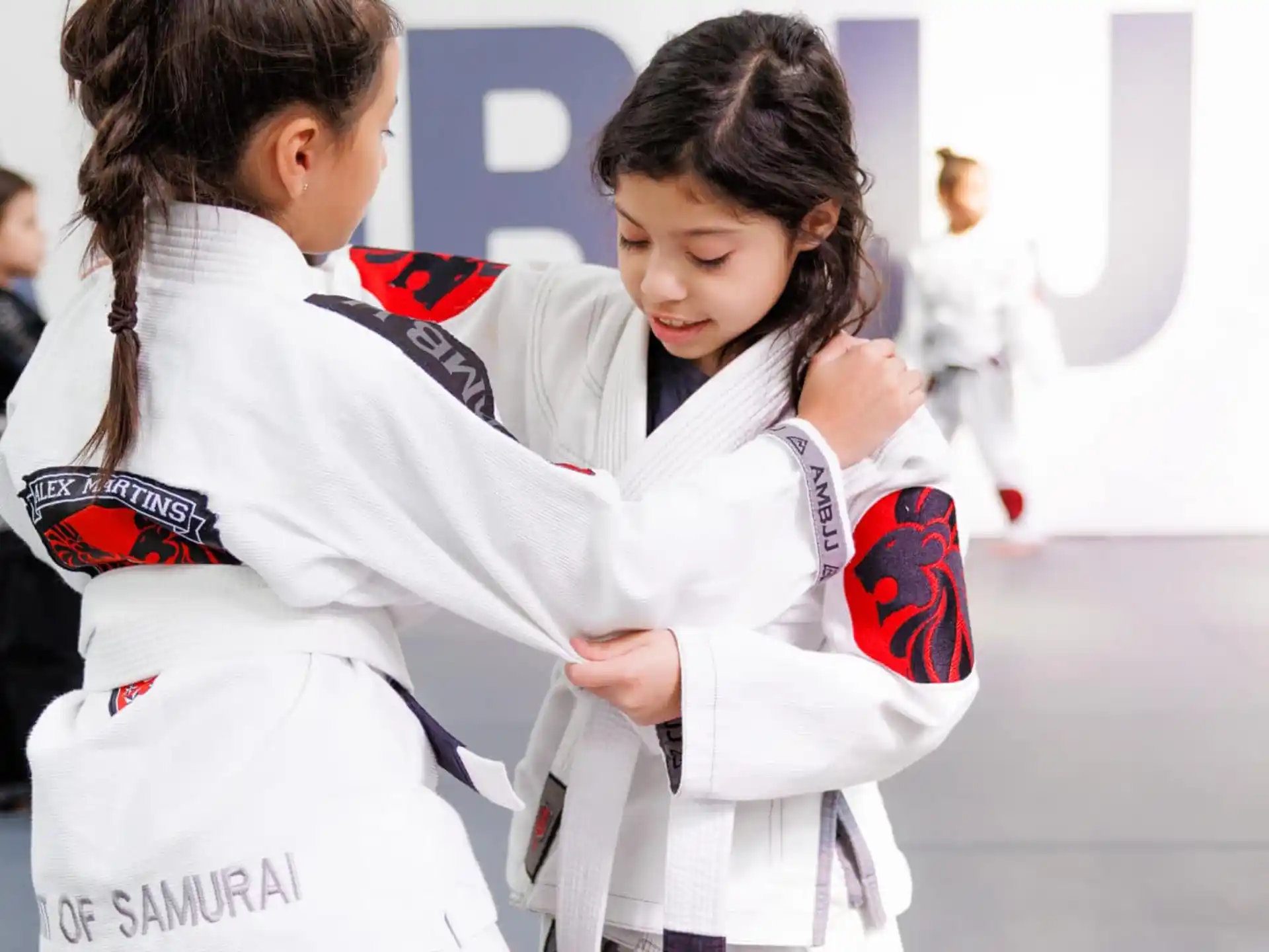 a couple of women in karate uniforms