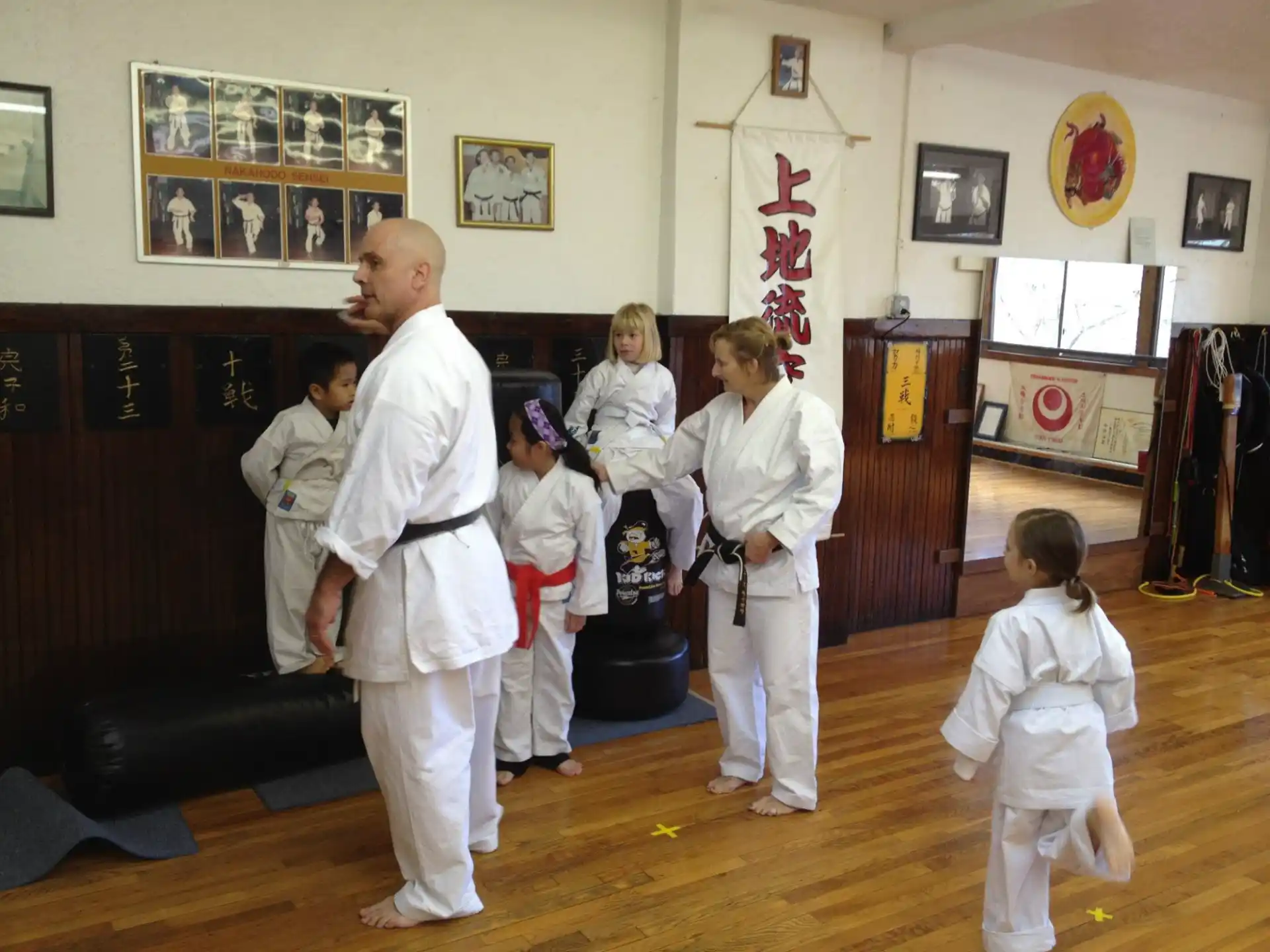 a group of people in white karate uniforms