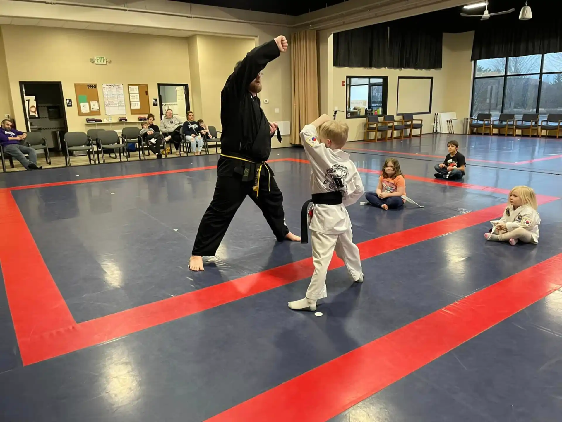a person and a child in a karate class