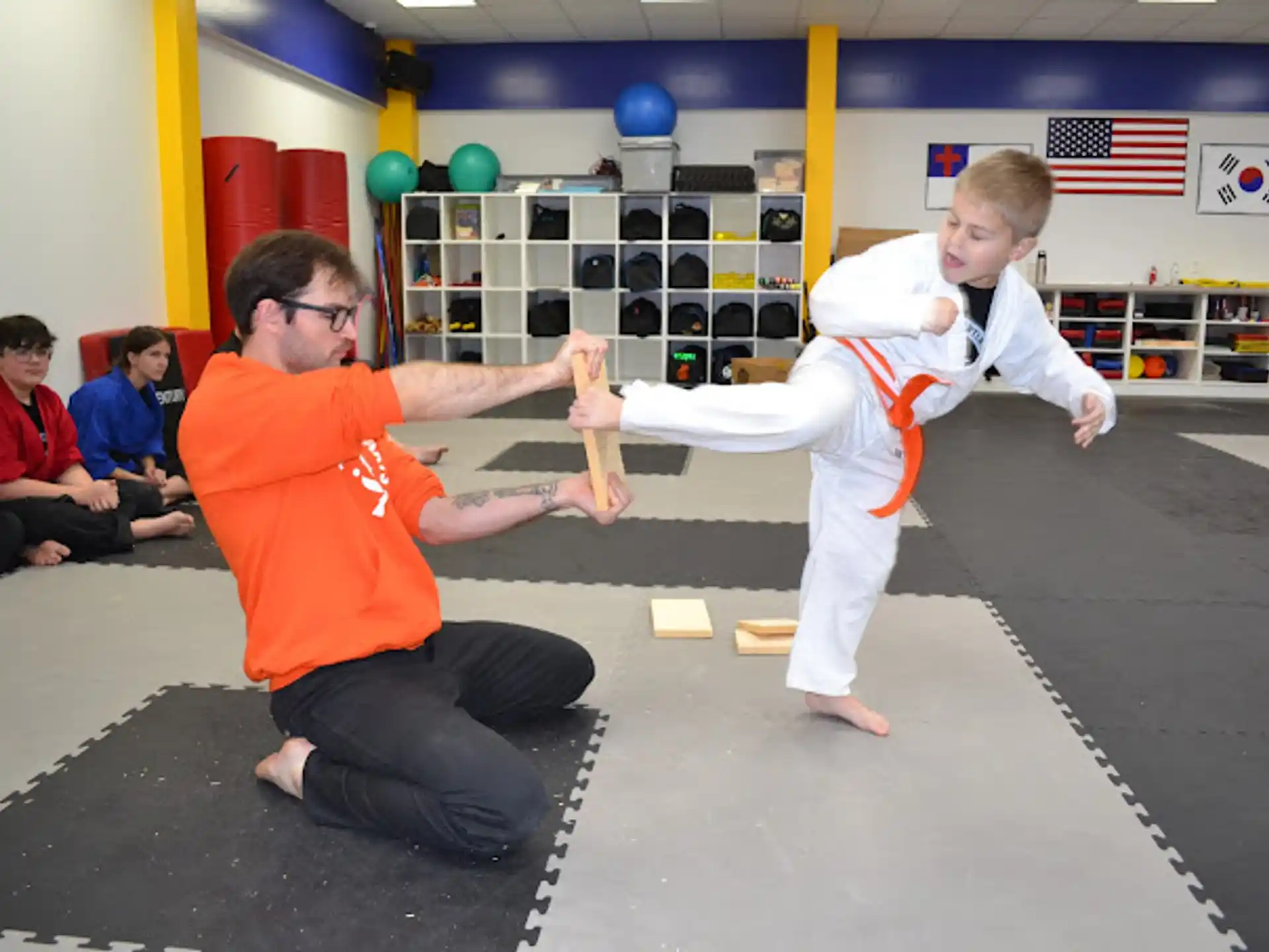 a person and a boy in a karate uniform