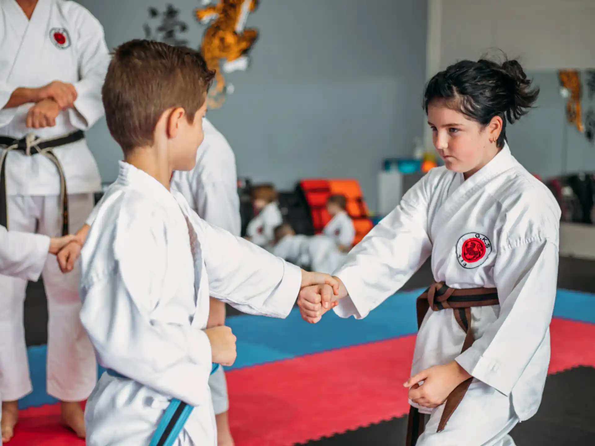 a boy and girl in karate uniforms