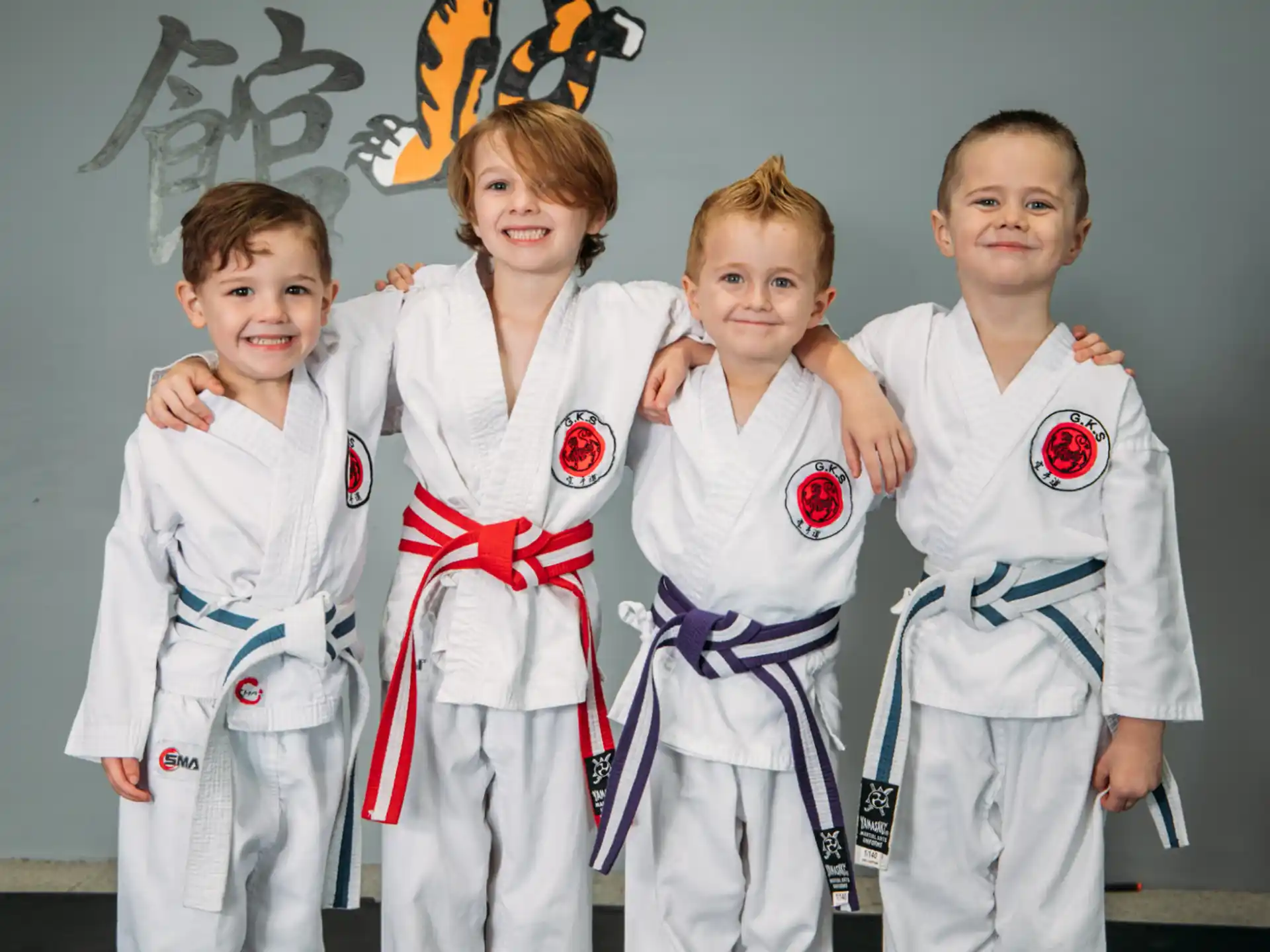 a group of kids in karate uniforms