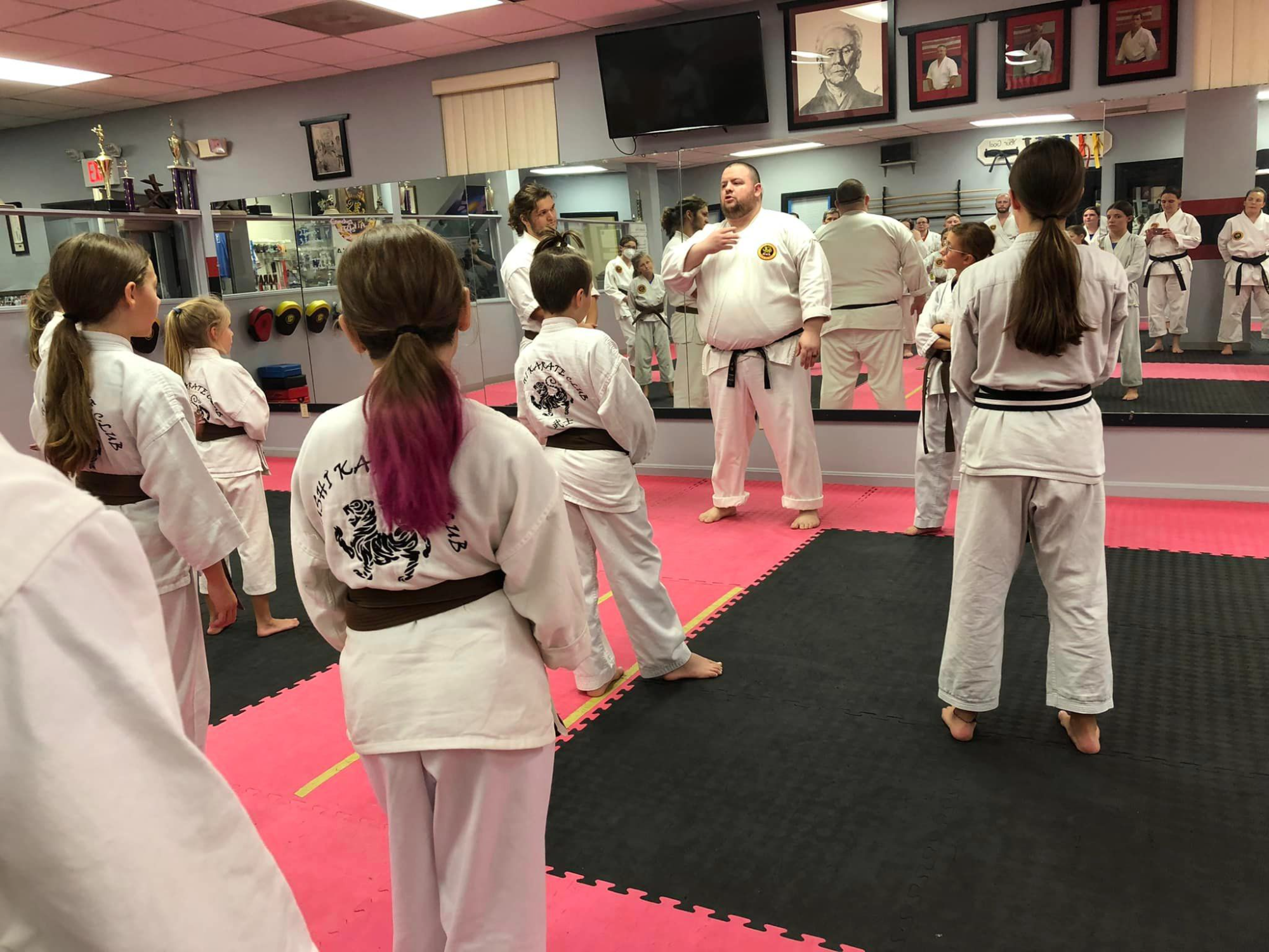 a group of people in white karate uniforms
