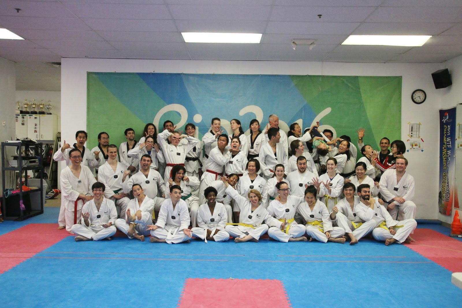 a group of people in white karate uniforms posing for a photo