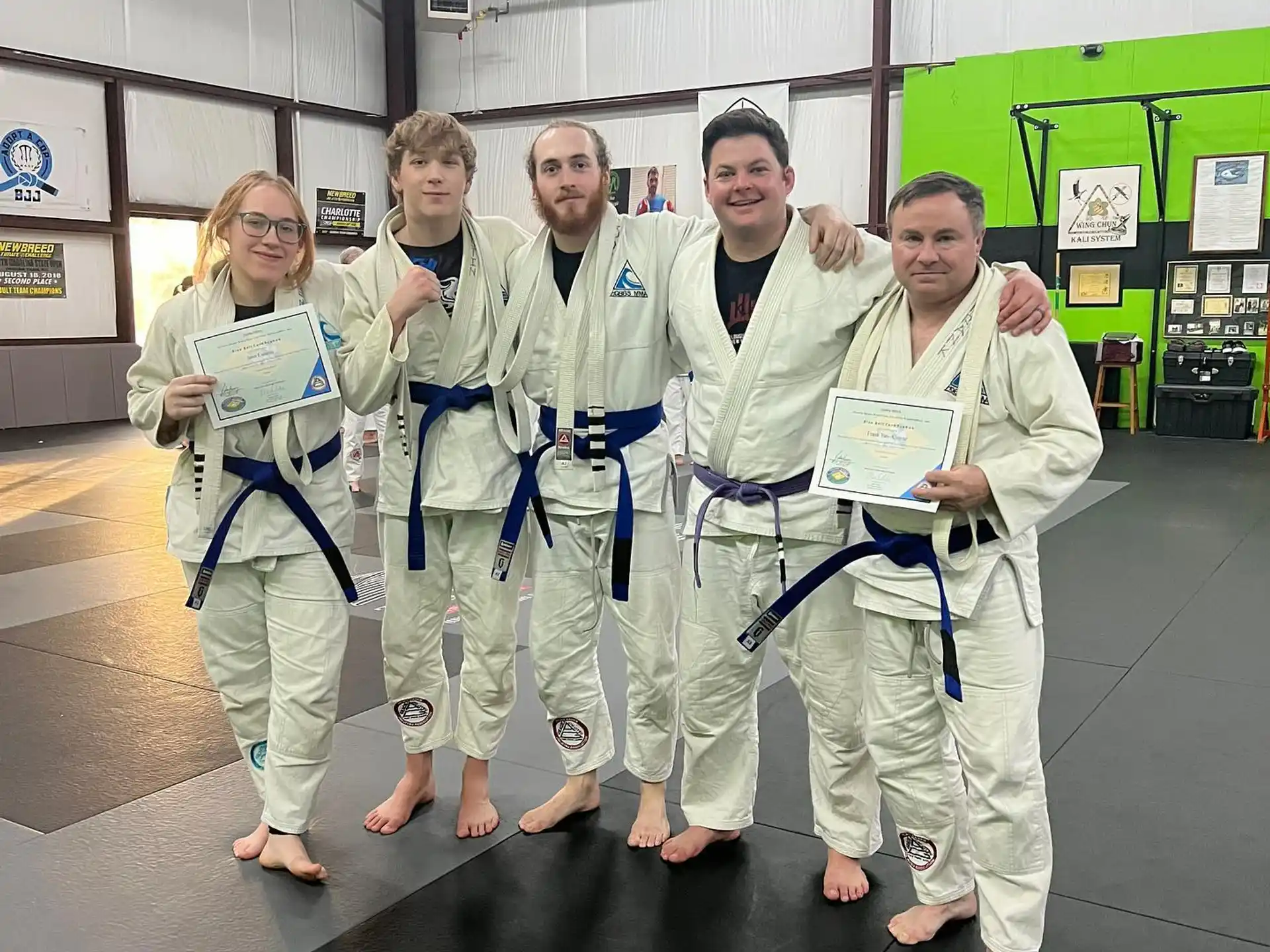 a group of people in white lab coats posing for a photo