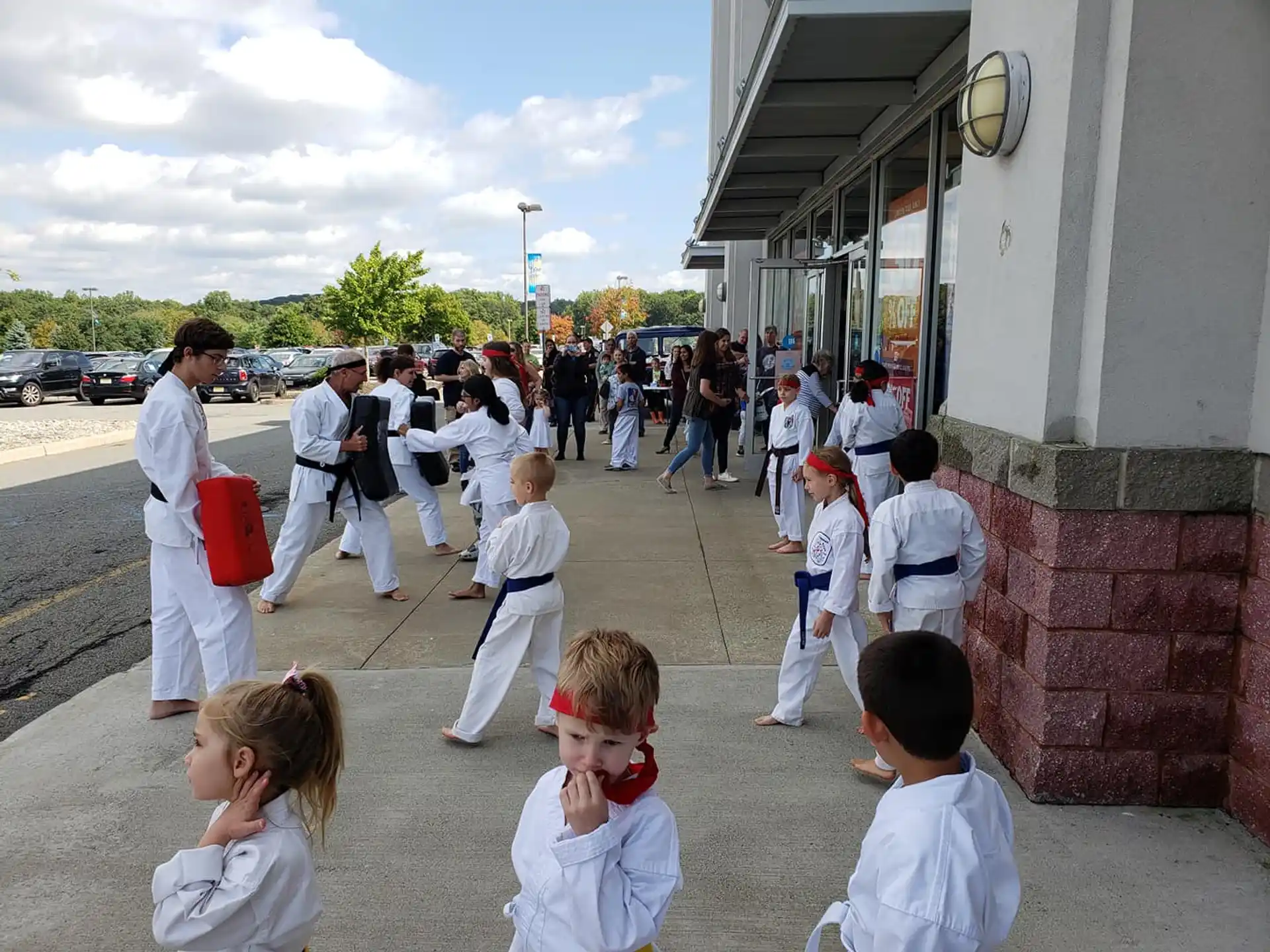 a group of people in white karate uniforms