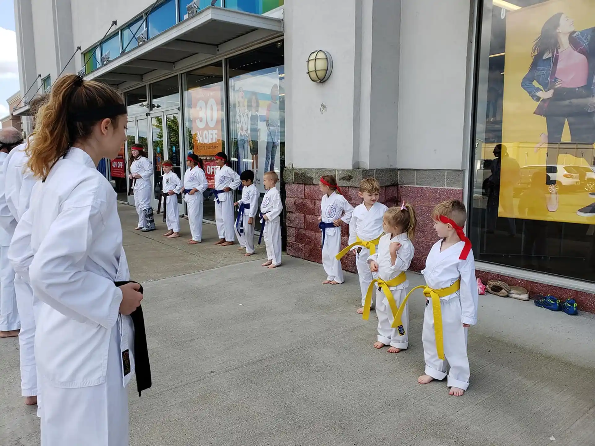 a person and a group of children in a line