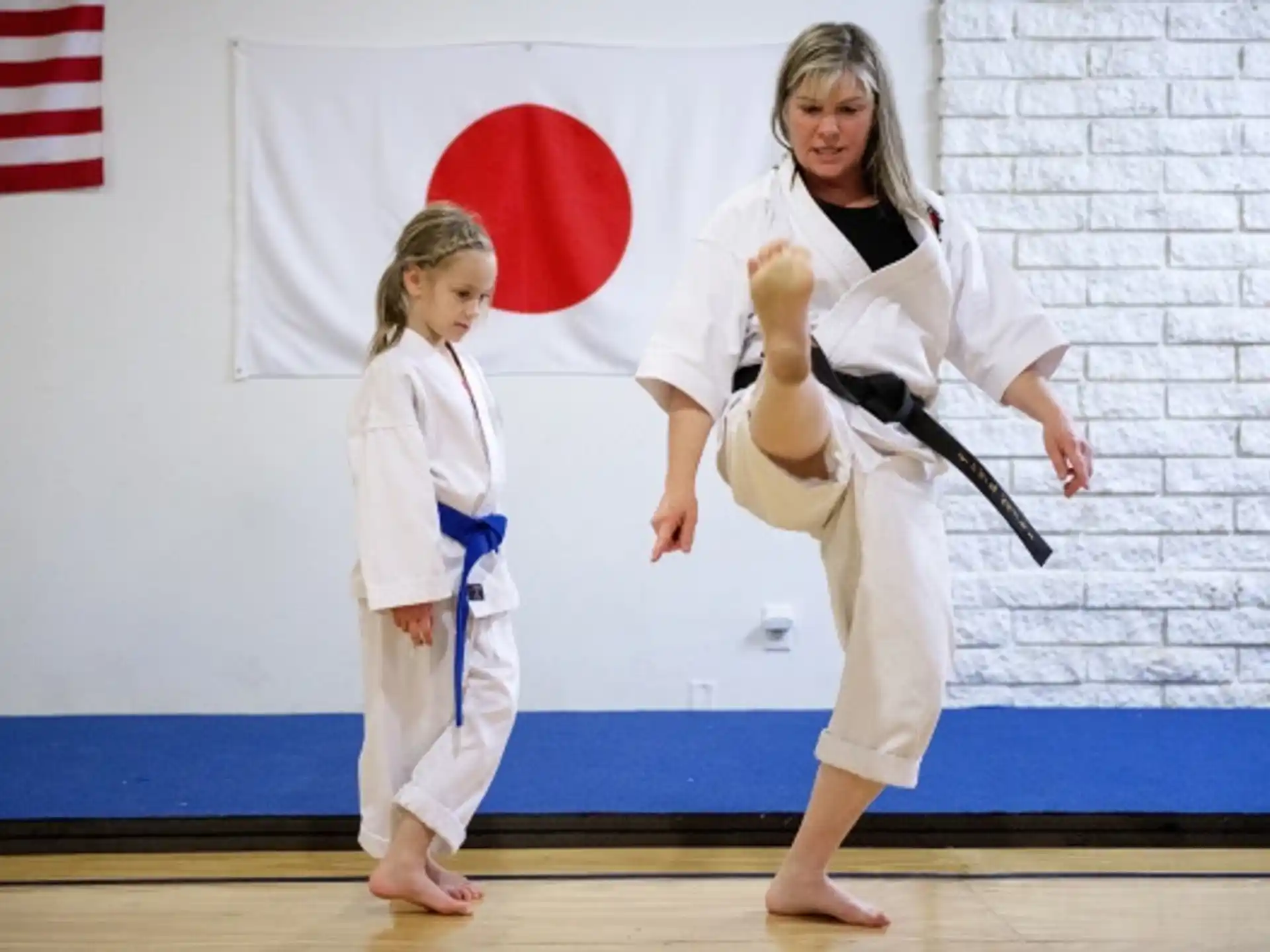 a couple of women in karate uniforms
