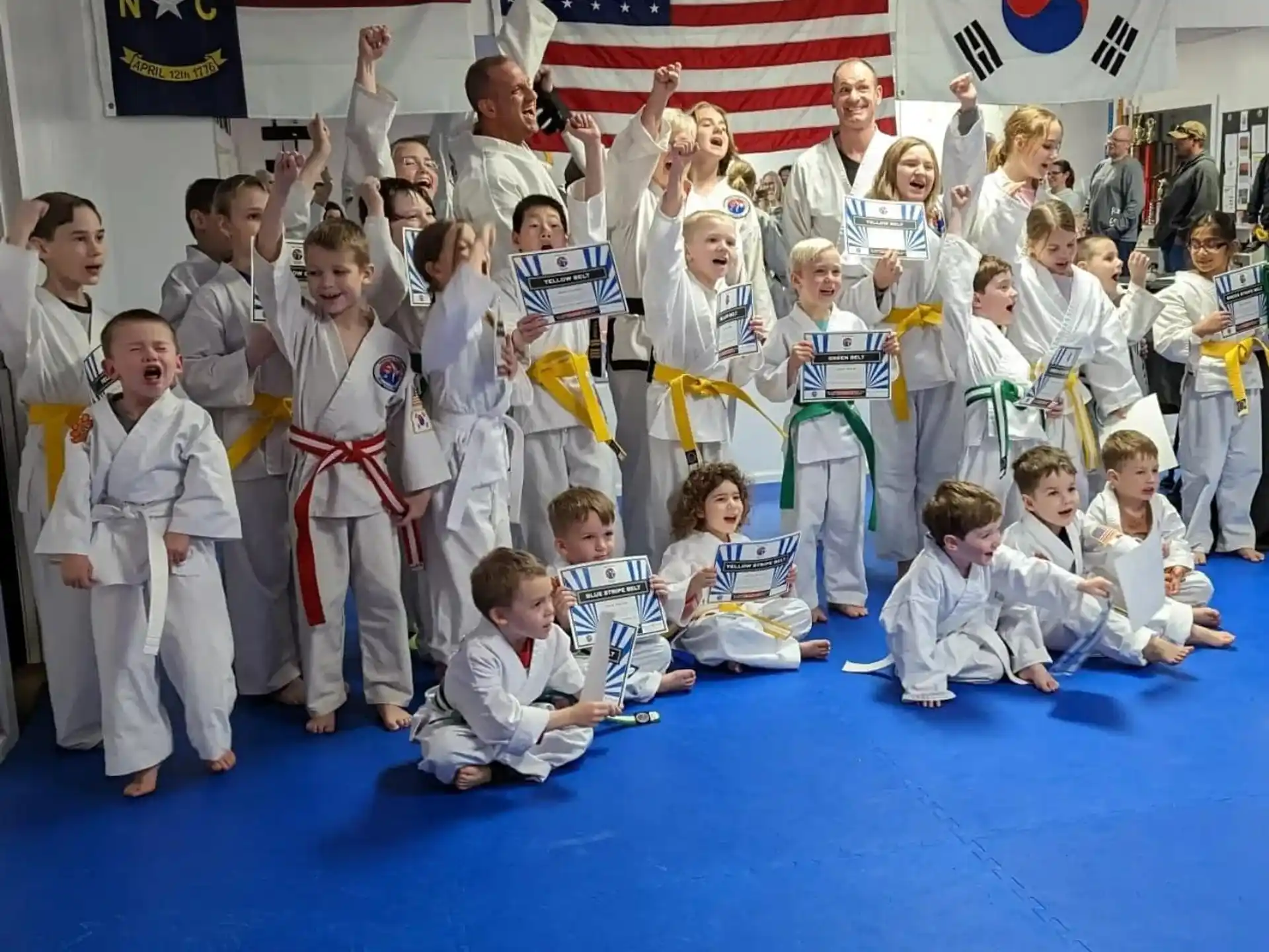 a group of children in karate uniforms