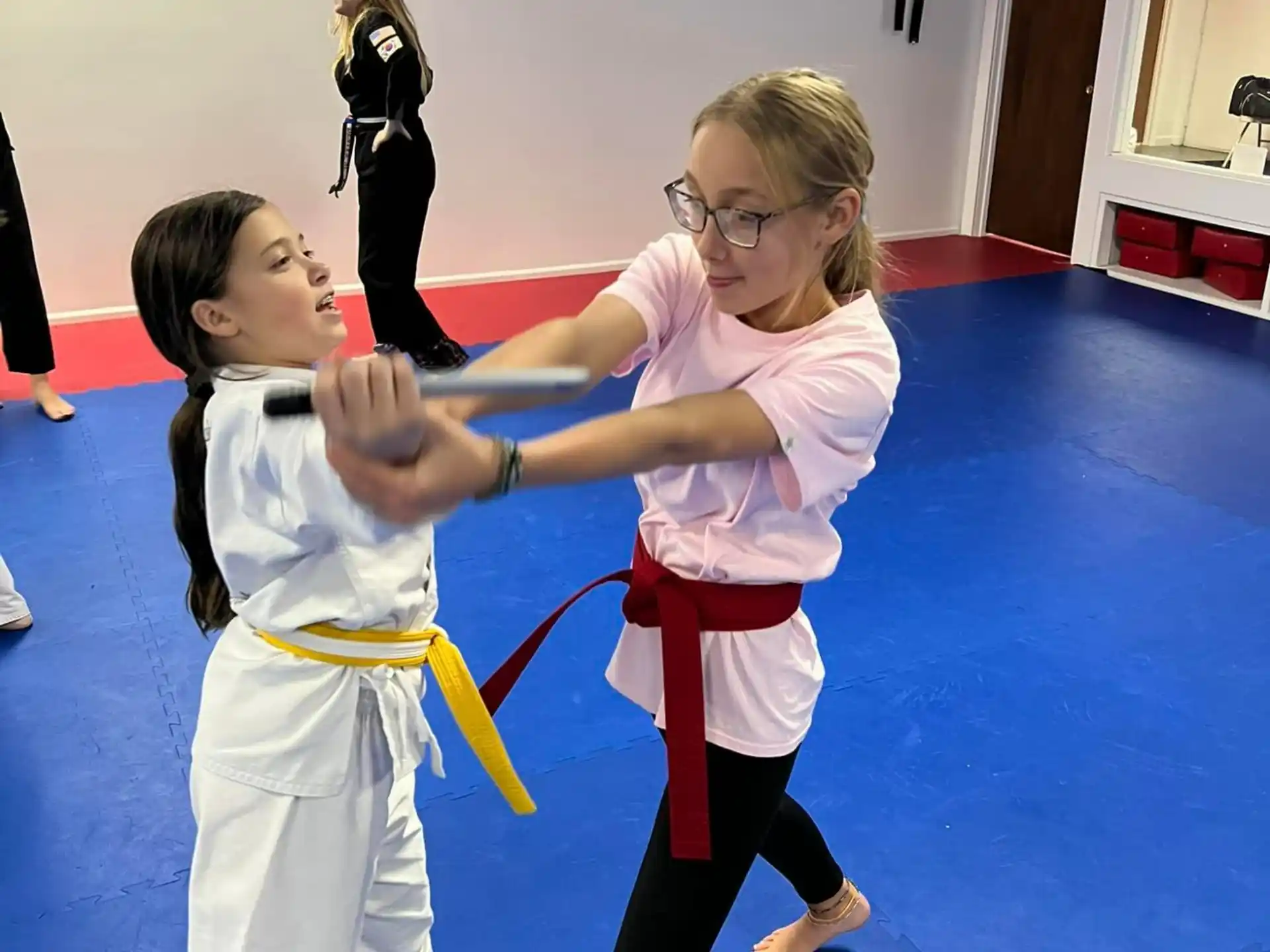 a man and a girl in karate uniforms