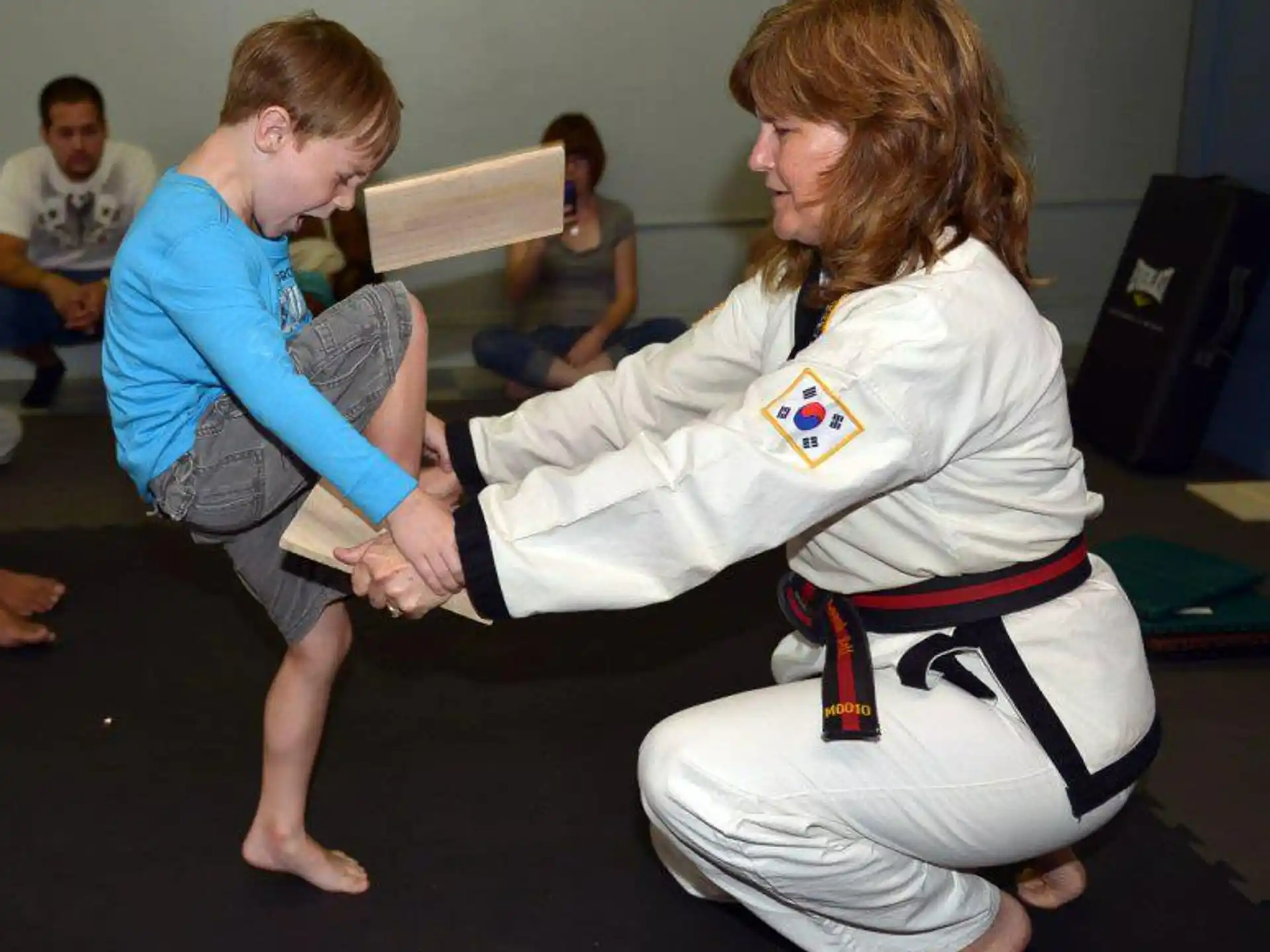 a woman in a karate uniform with a man in a uniform