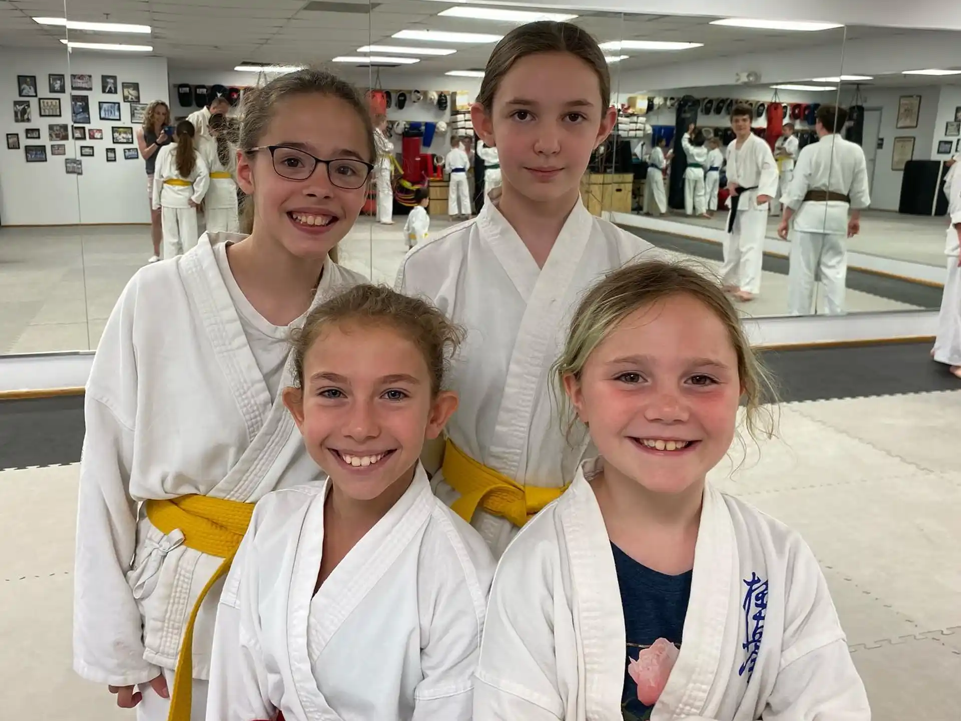 a group of people in white karate uniforms