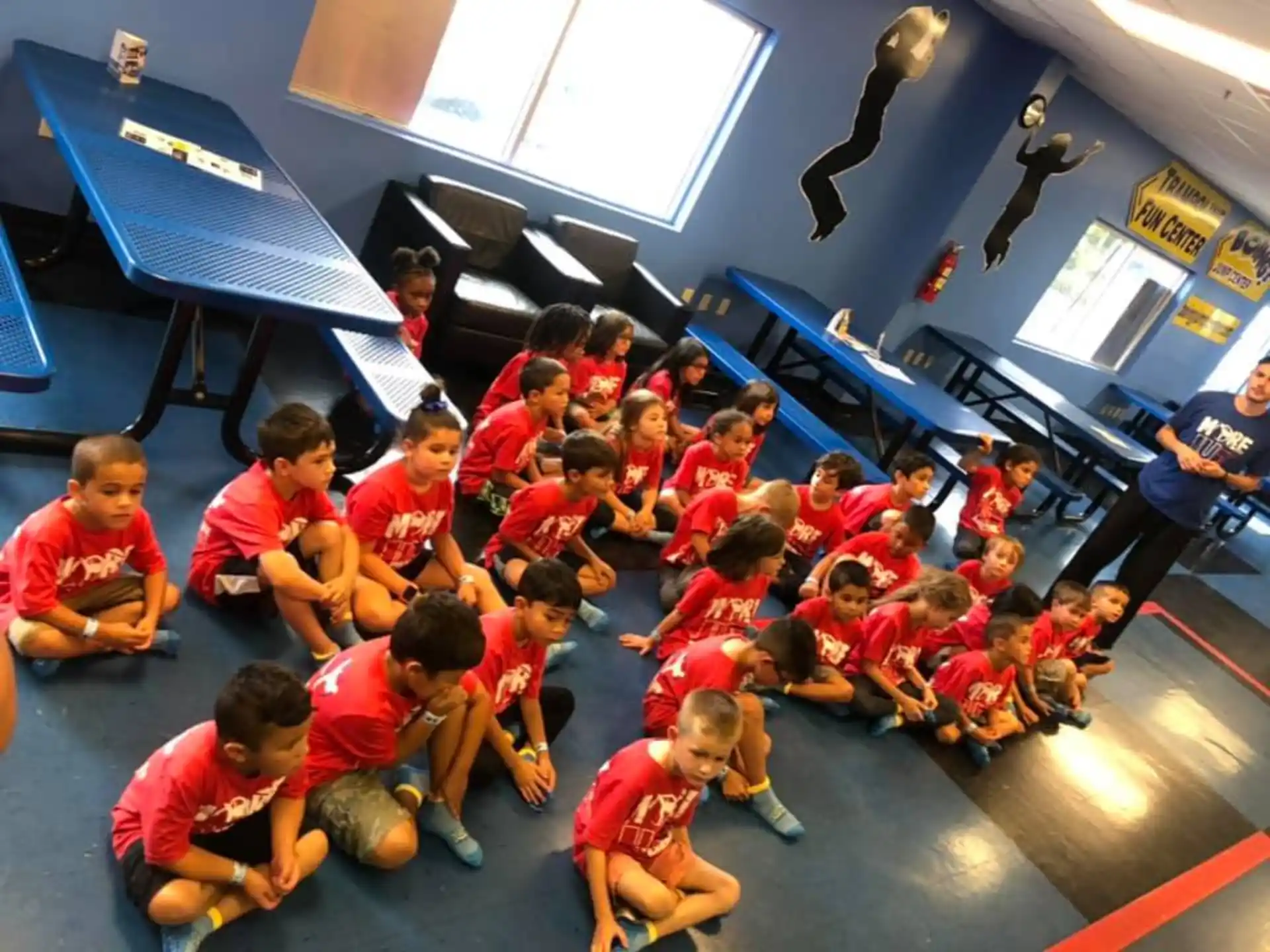 a group of children sitting on the floor in a room