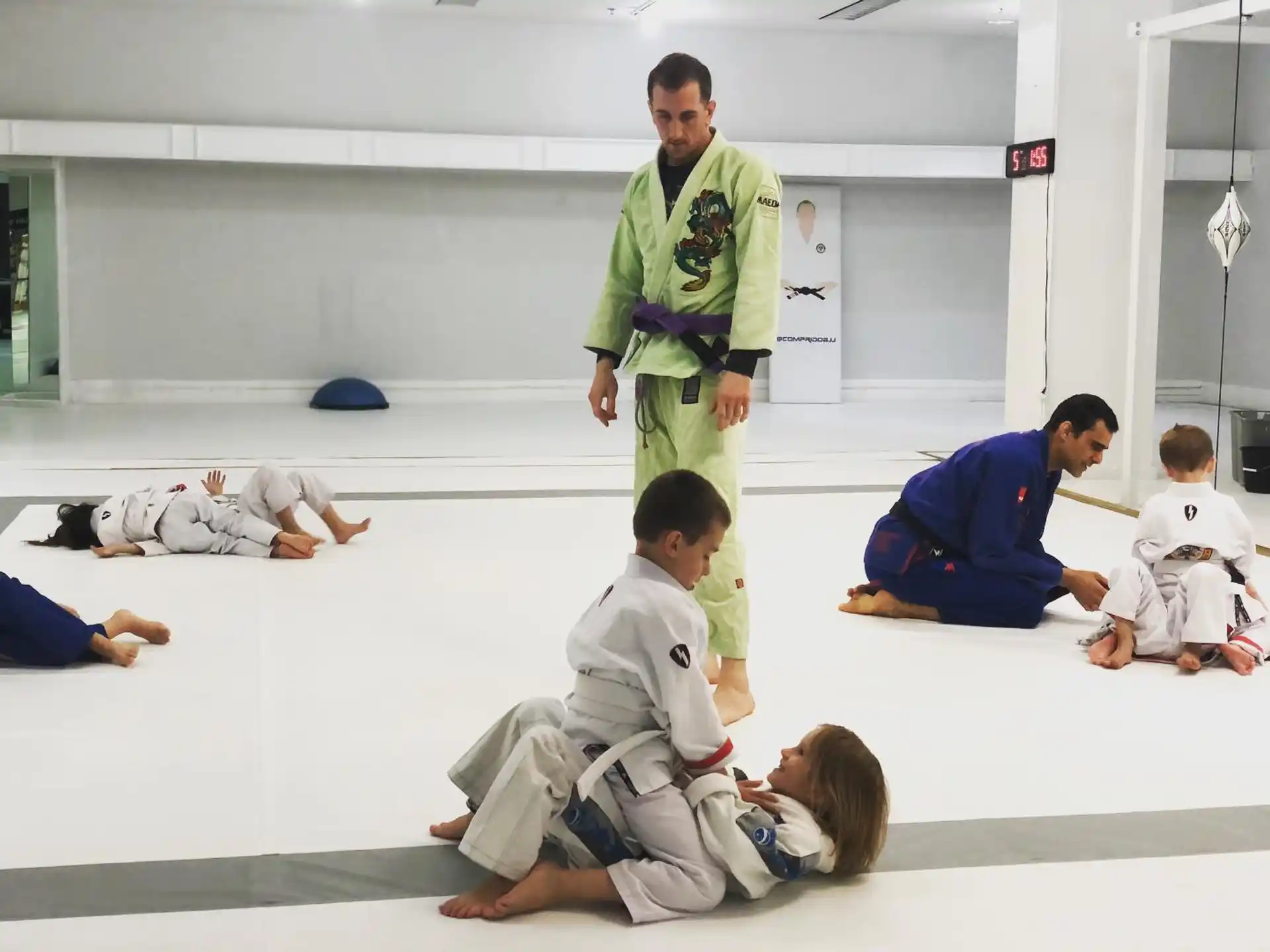 a person standing in front of a group of people sitting on the floor