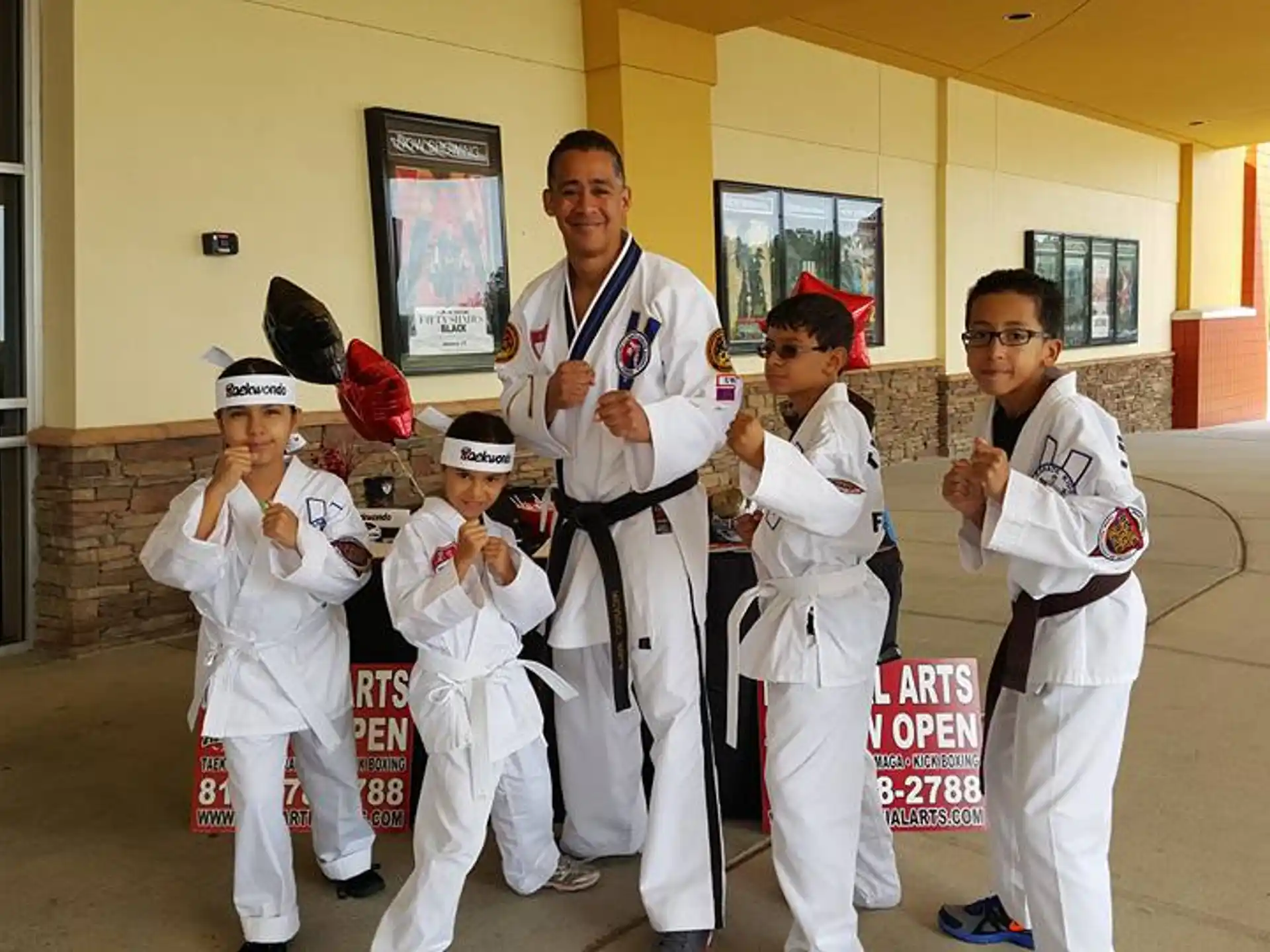 a group of people in white karate uniforms