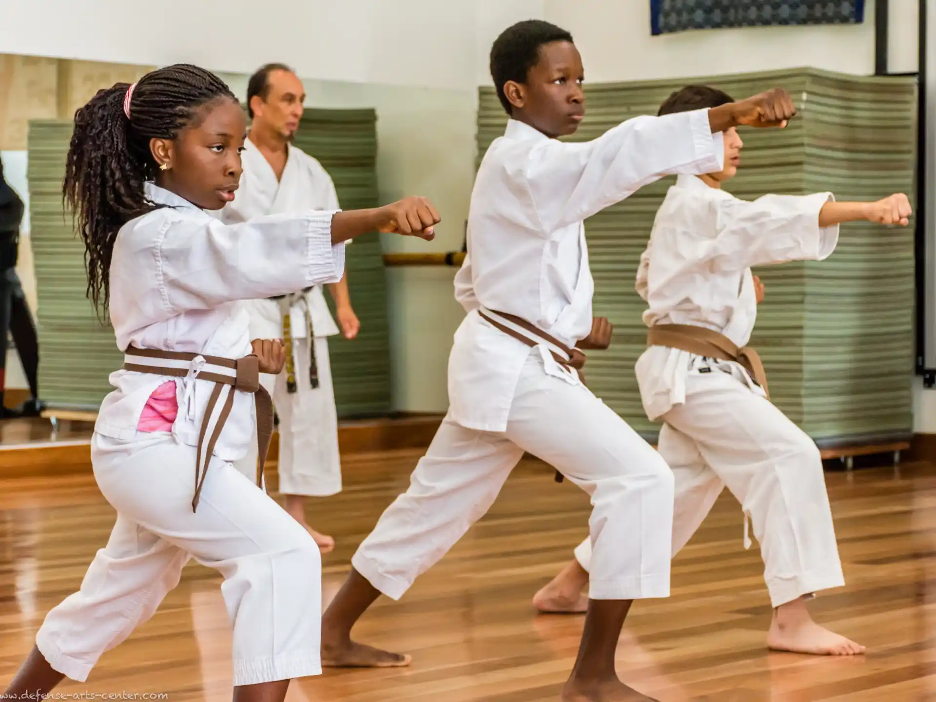 a group of people in karate uniforms