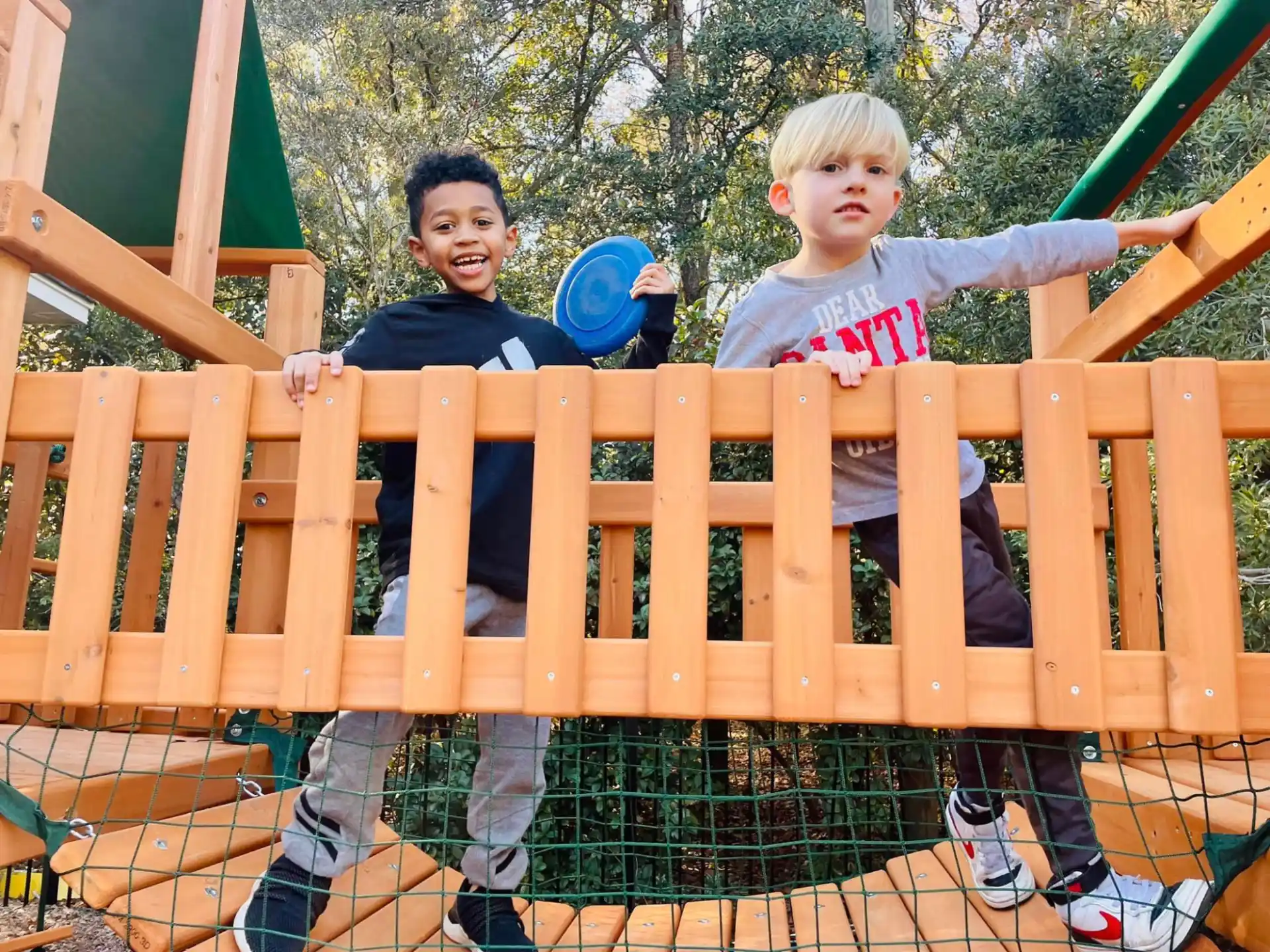 a couple of boys playing on a playground