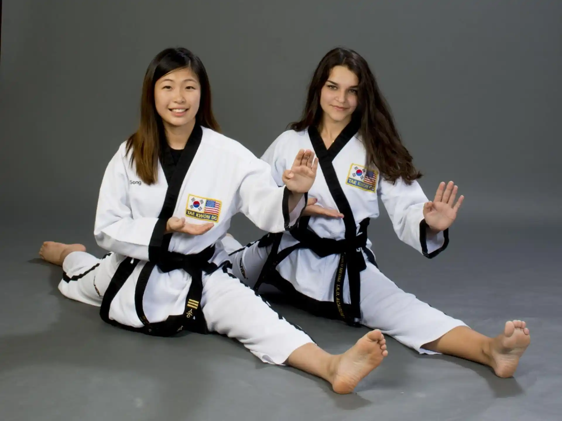 a couple of women in karate uniforms