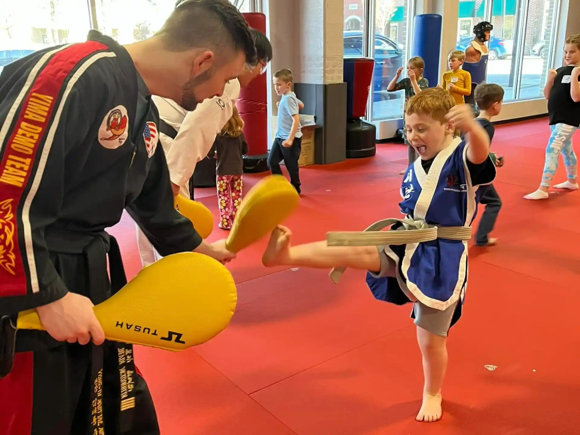 a person and a boy in a gym
