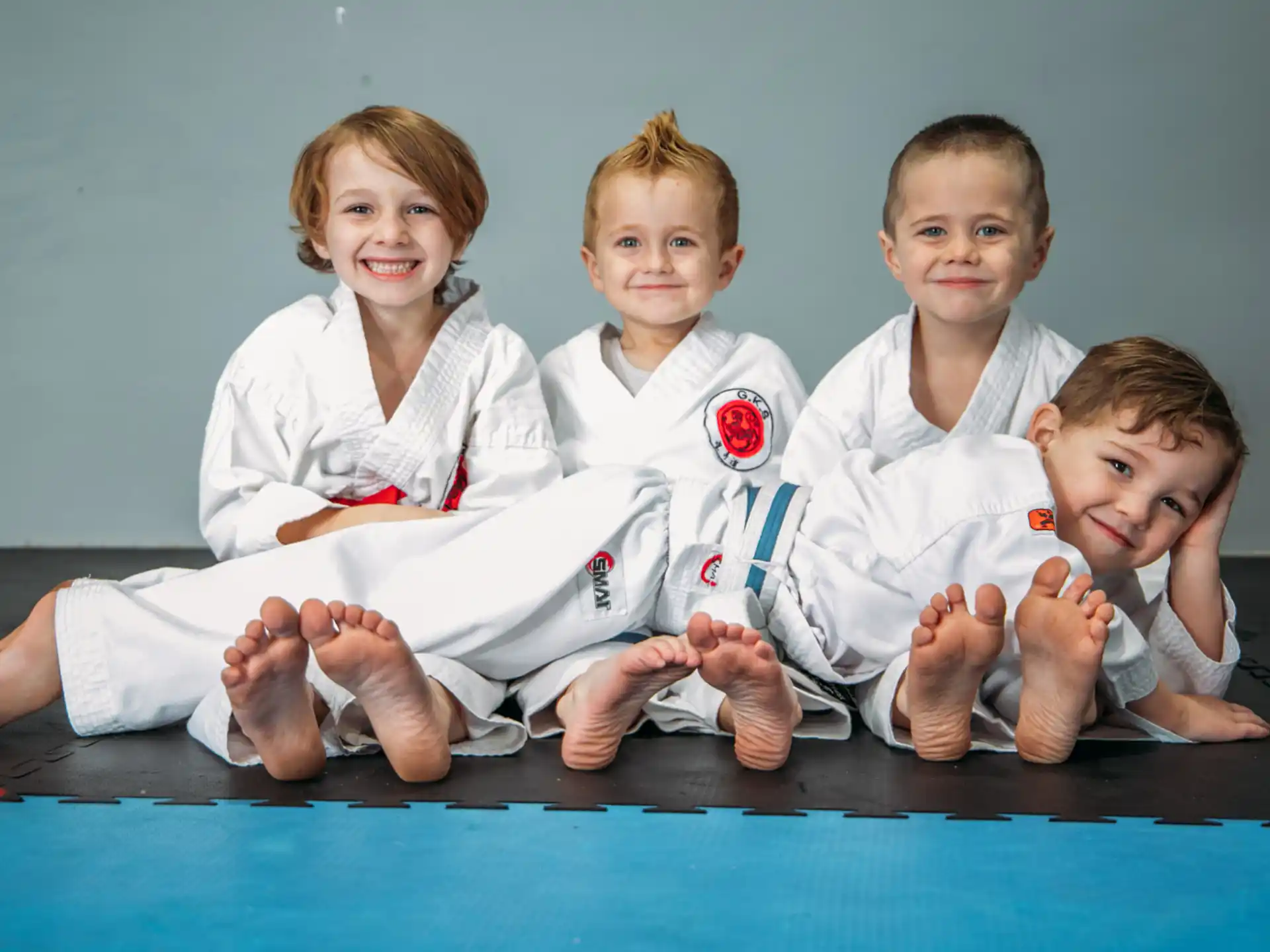 a group of kids in karate uniforms