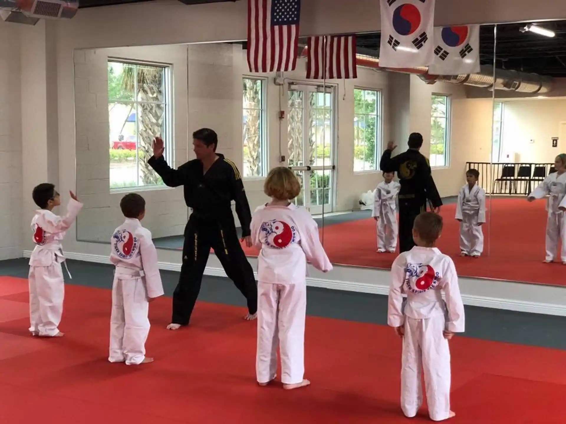 a group of kids in karate uniforms