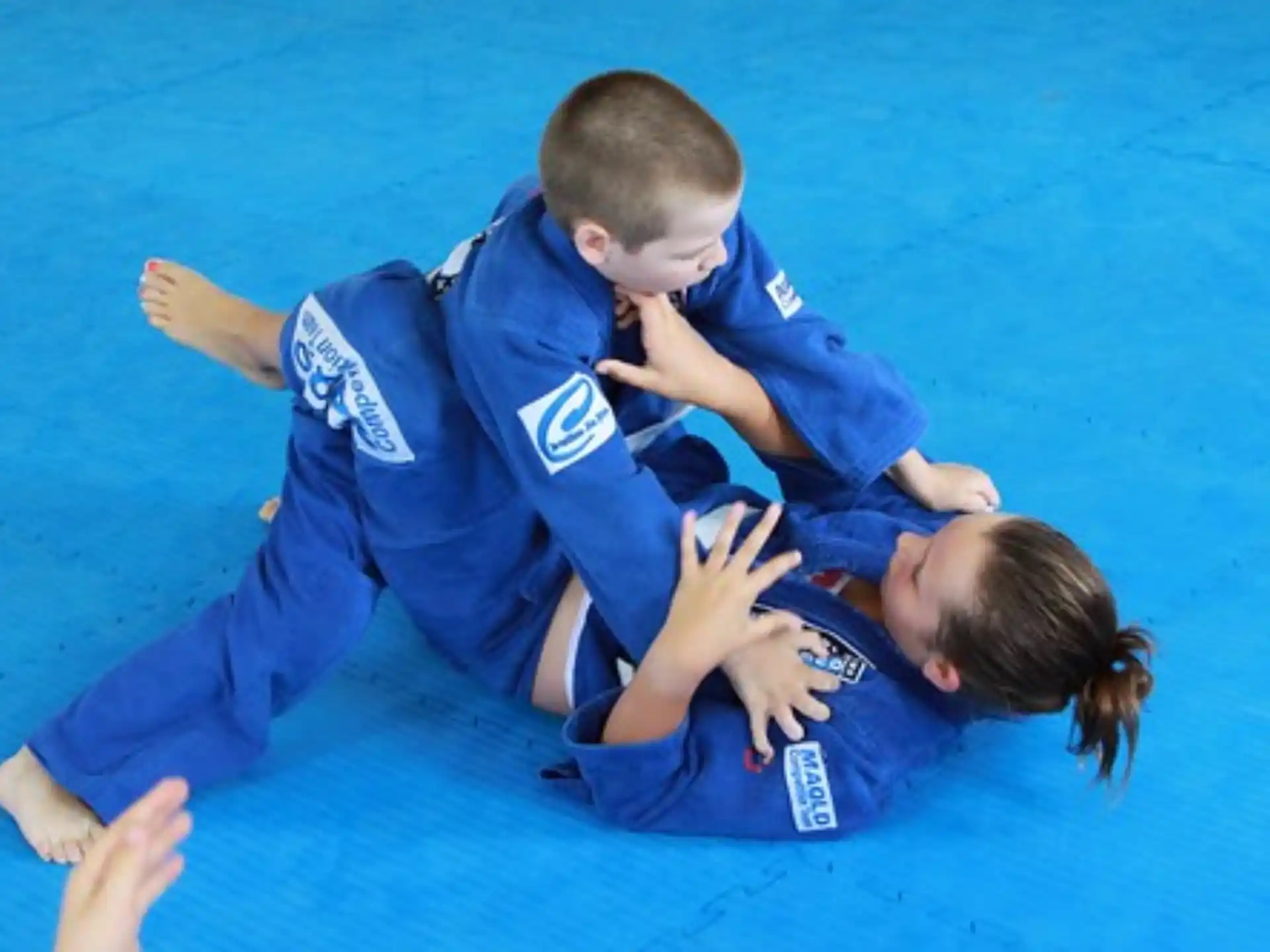 a few children in blue uniforms