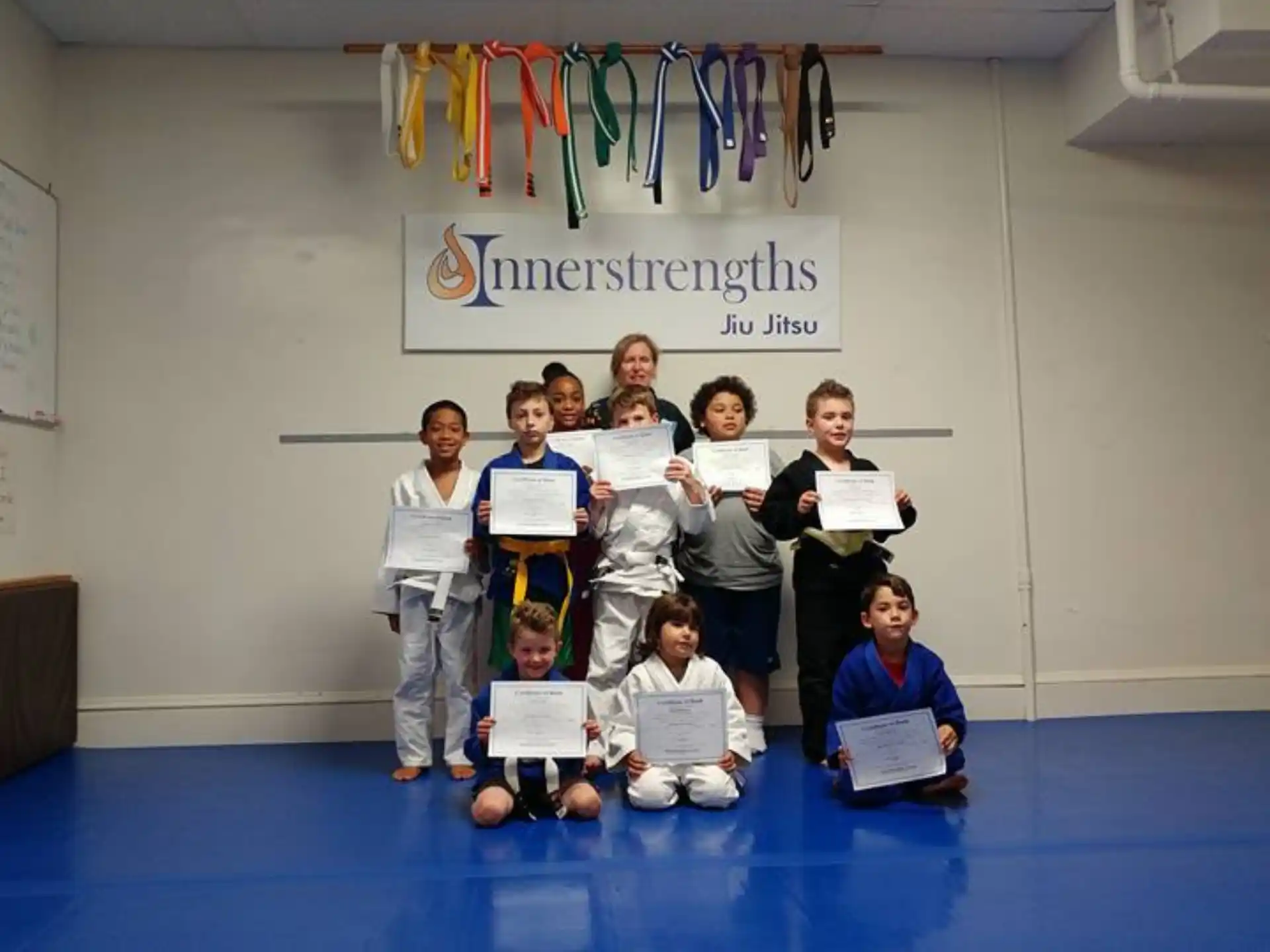 a group of people holding certificates