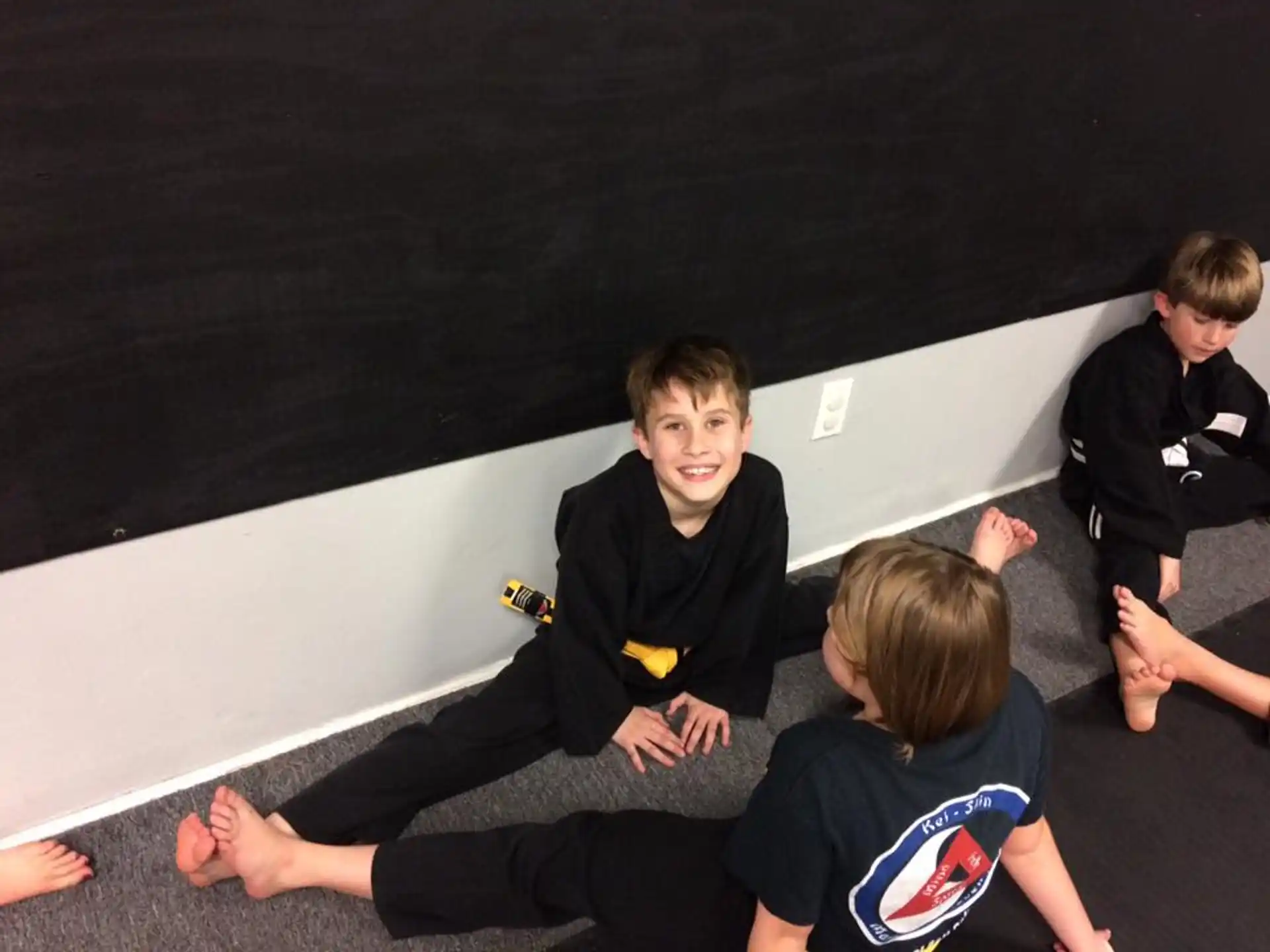 a group of boys sitting on the floor