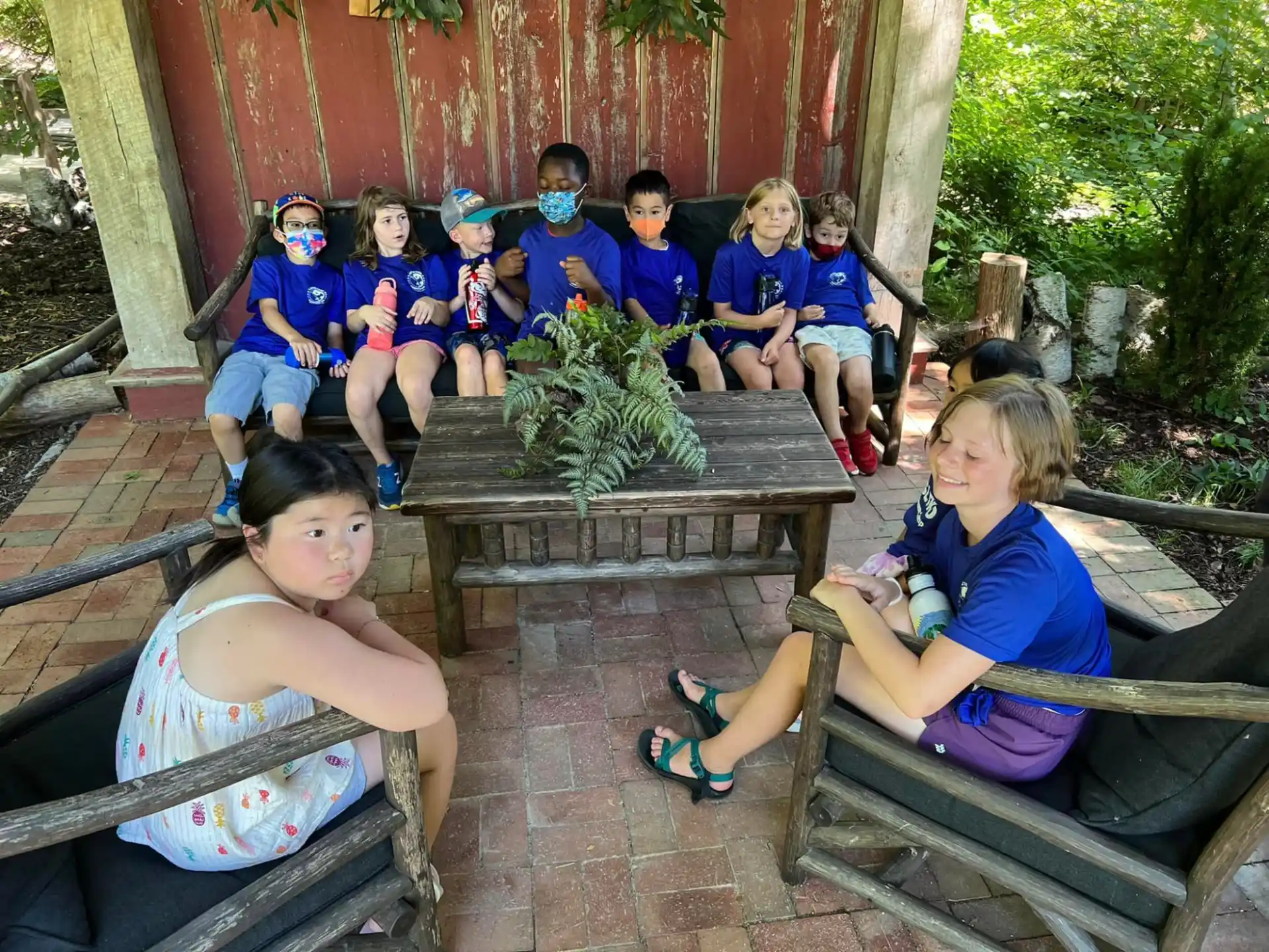 a group of children sitting on a bench
