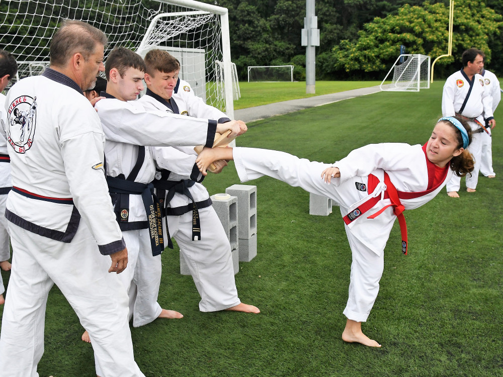 a group of people in karate uniforms