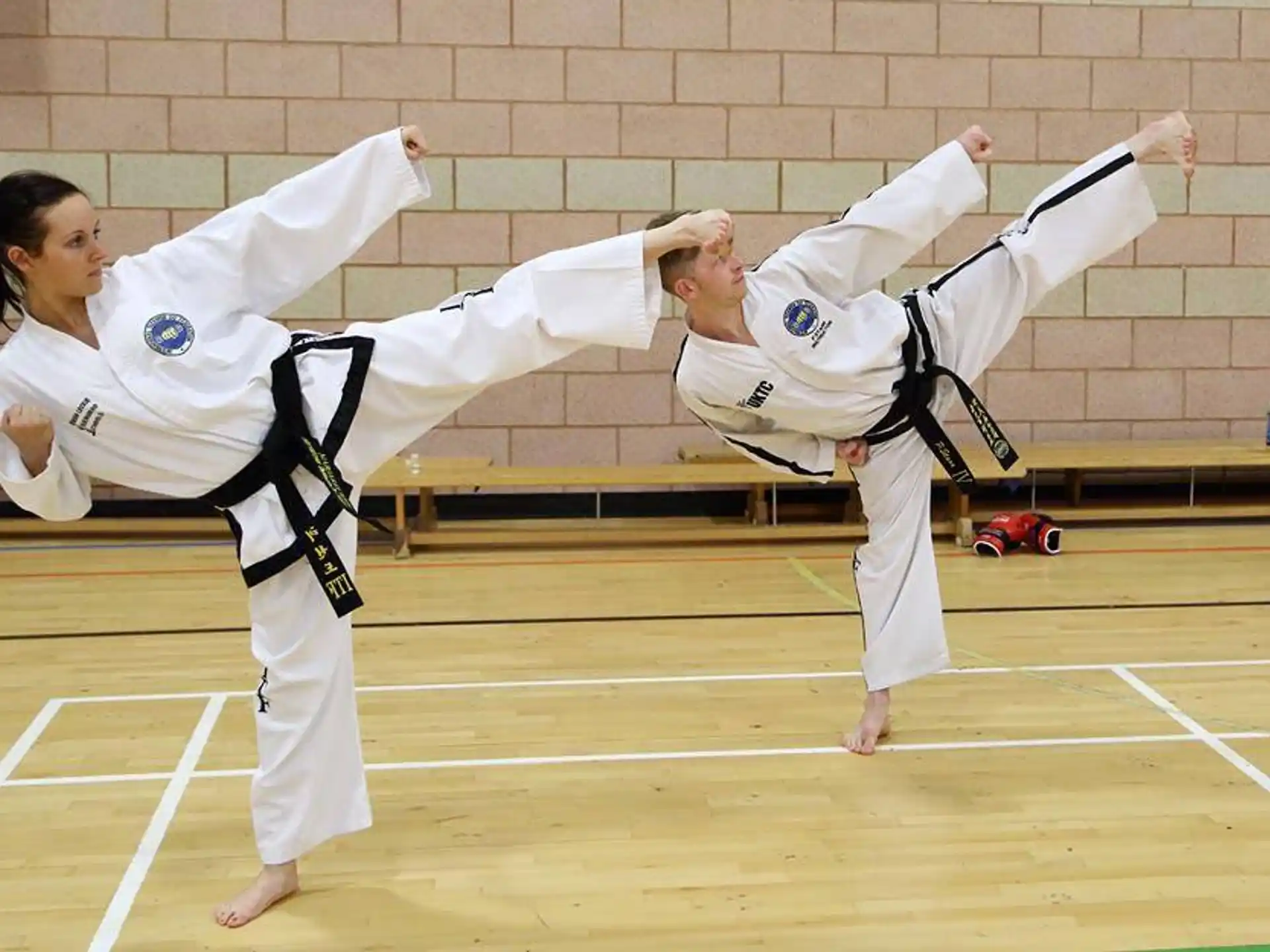 a man and woman in karate uniforms