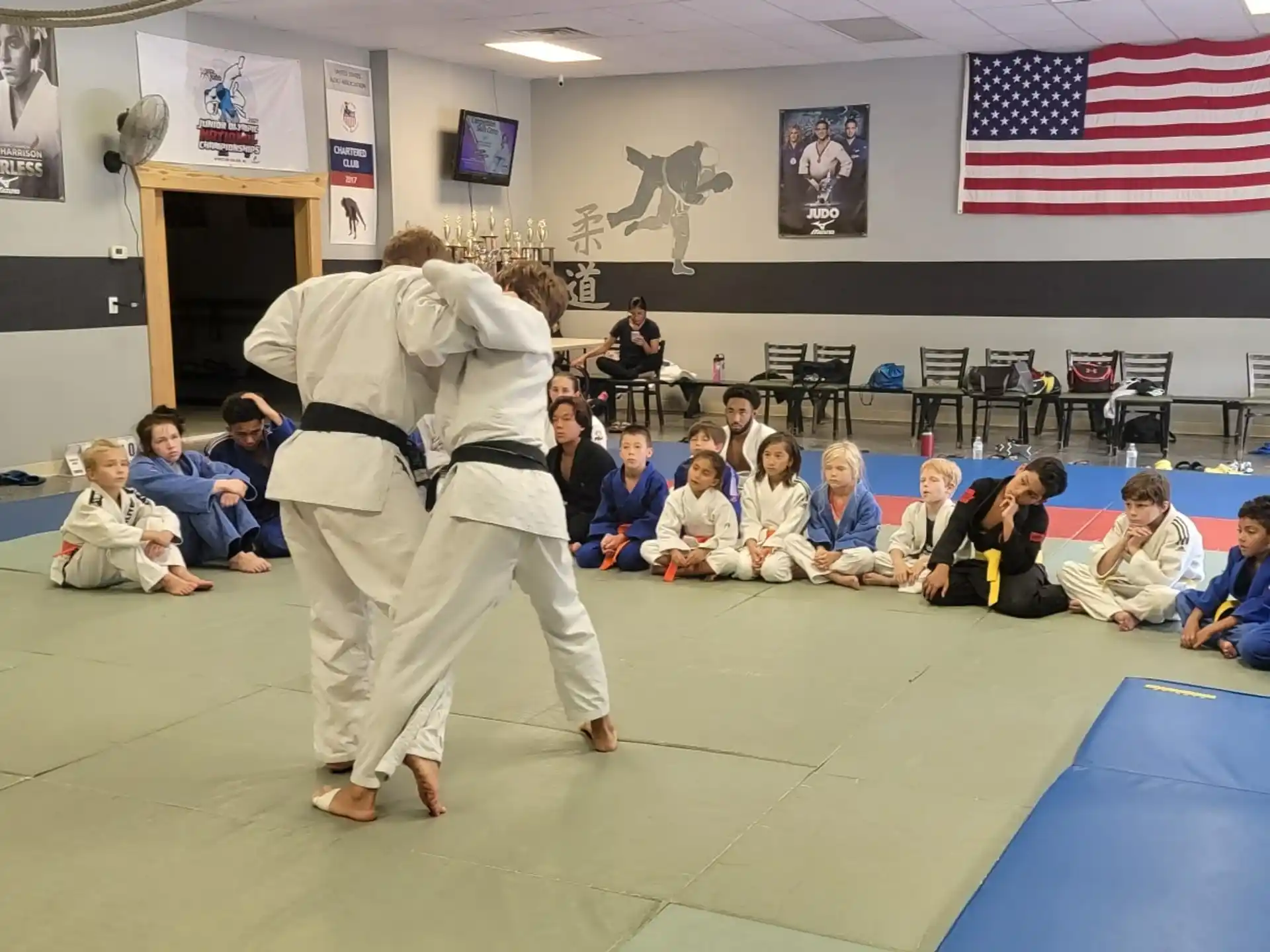 a man in a karate uniform standing in front of a group of people