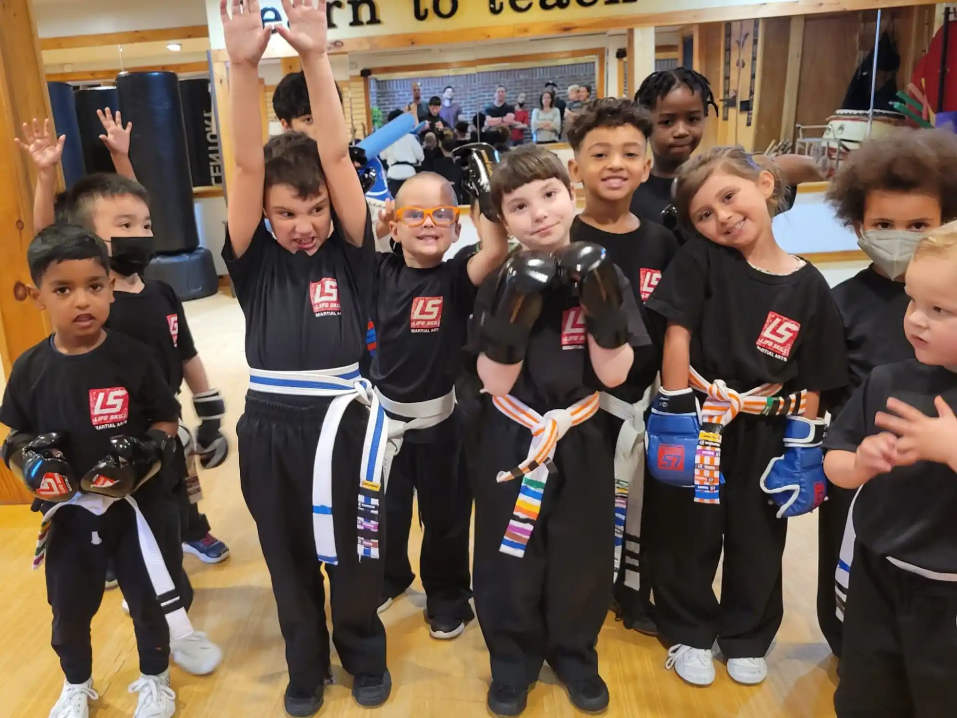 a group of children in black uniforms