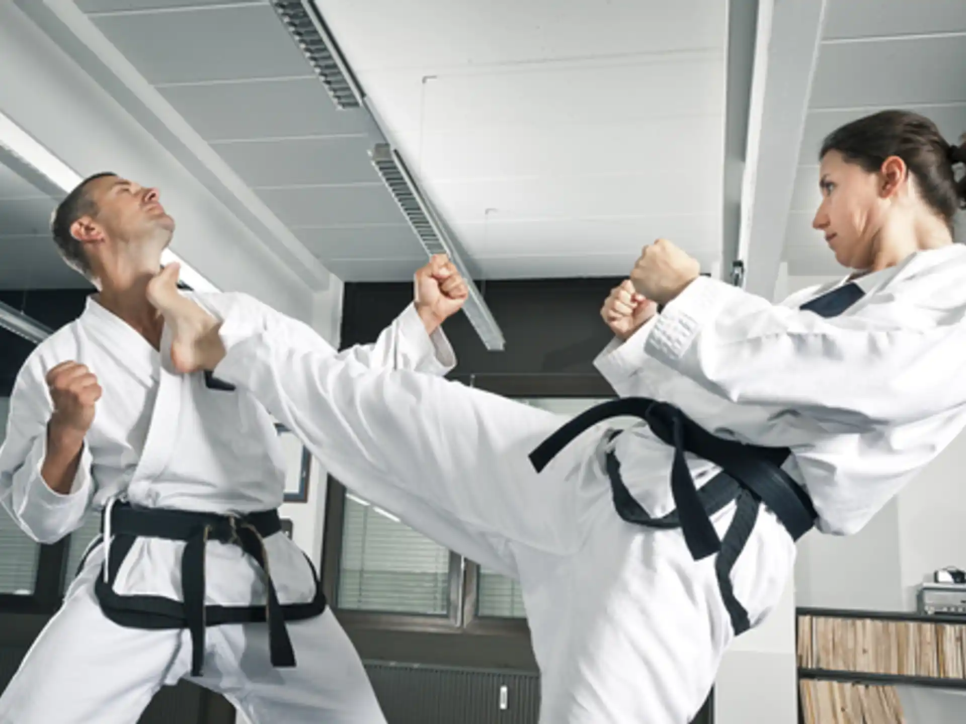 a man and a woman in karate uniforms
