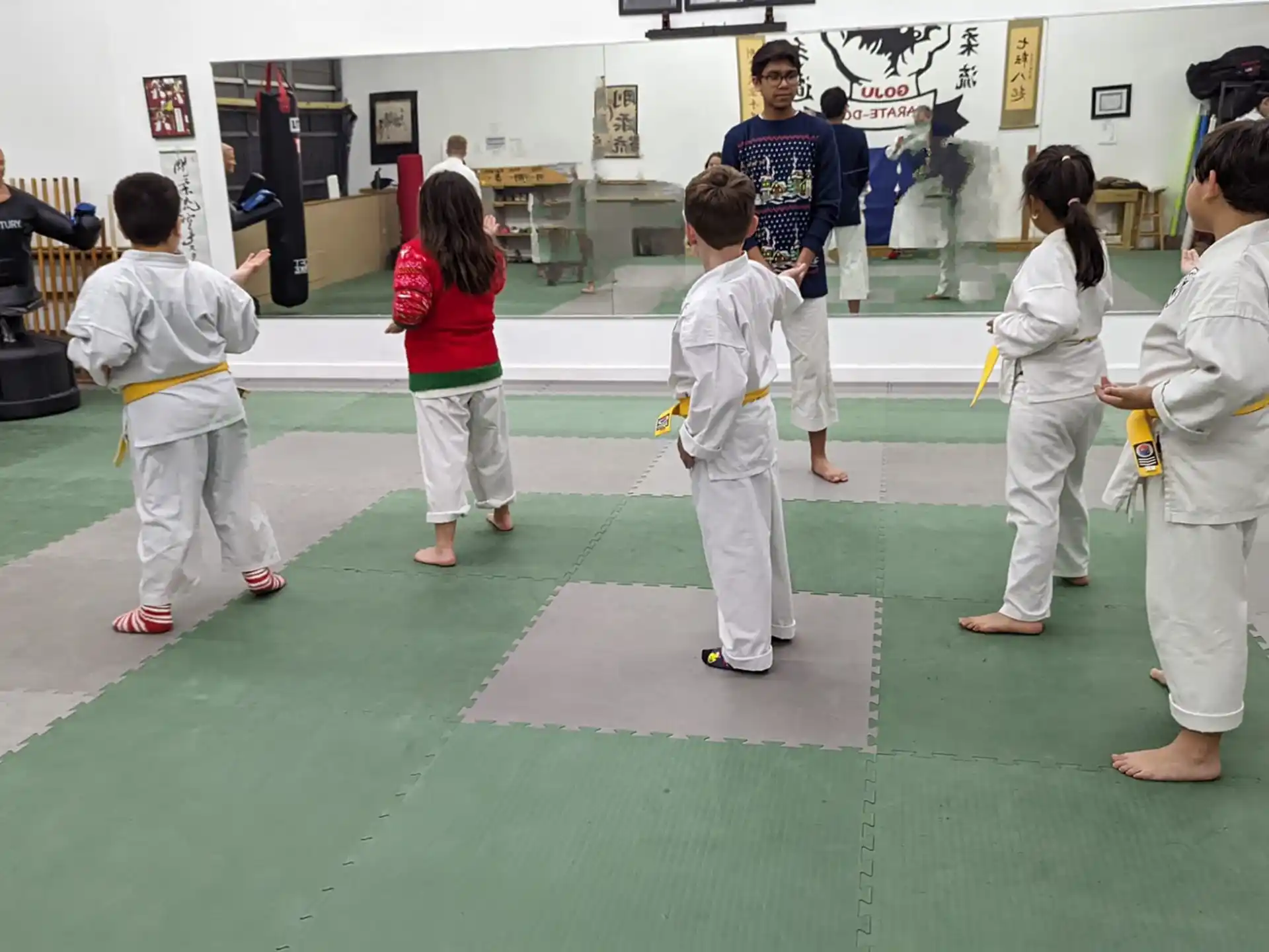 a group of children in karate uniforms