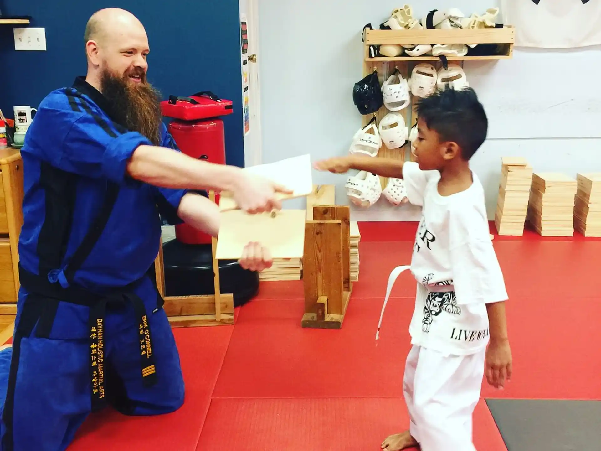 a man and a boy in karate uniforms