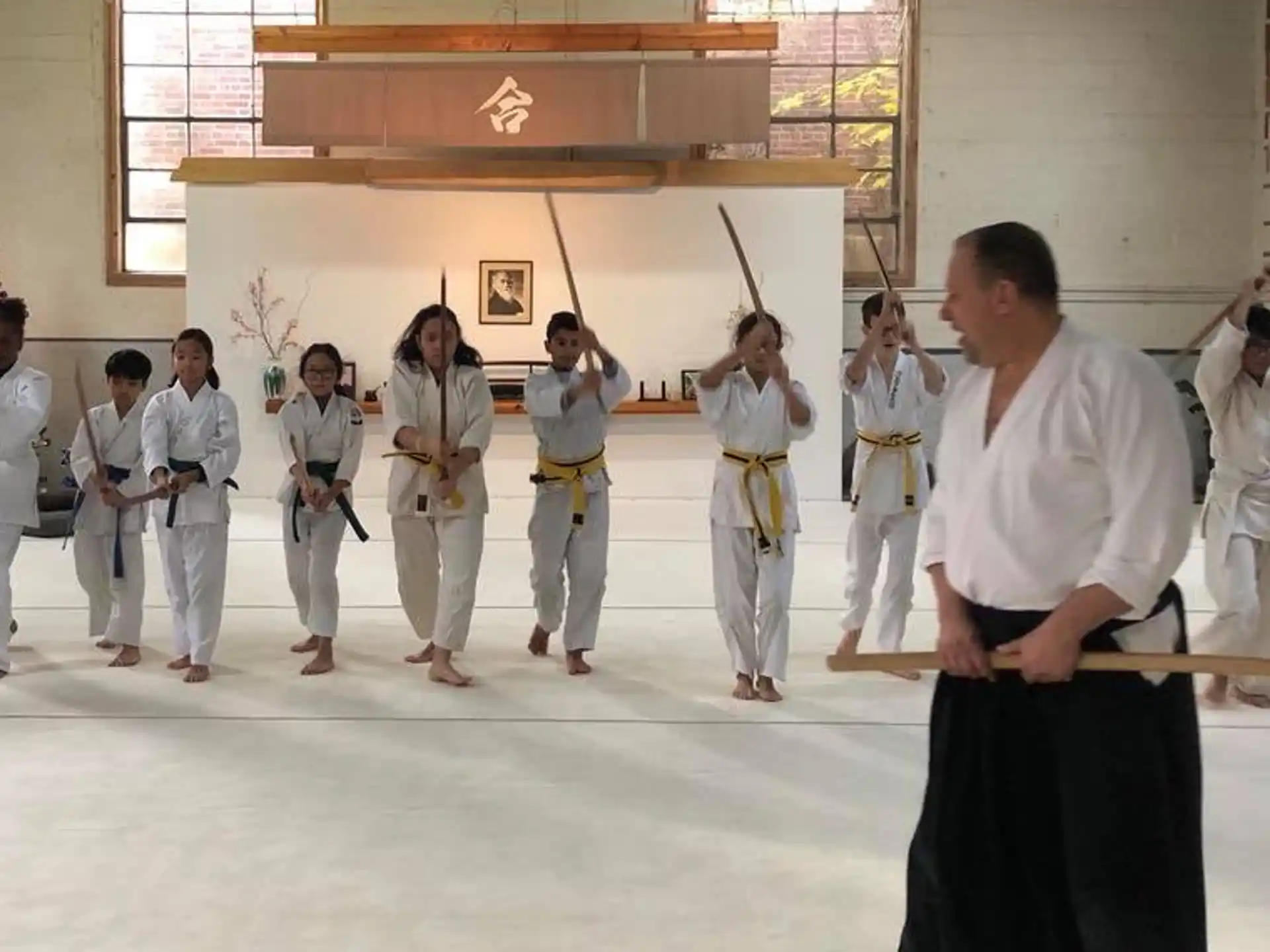 a person standing in front of a group of people in white robes