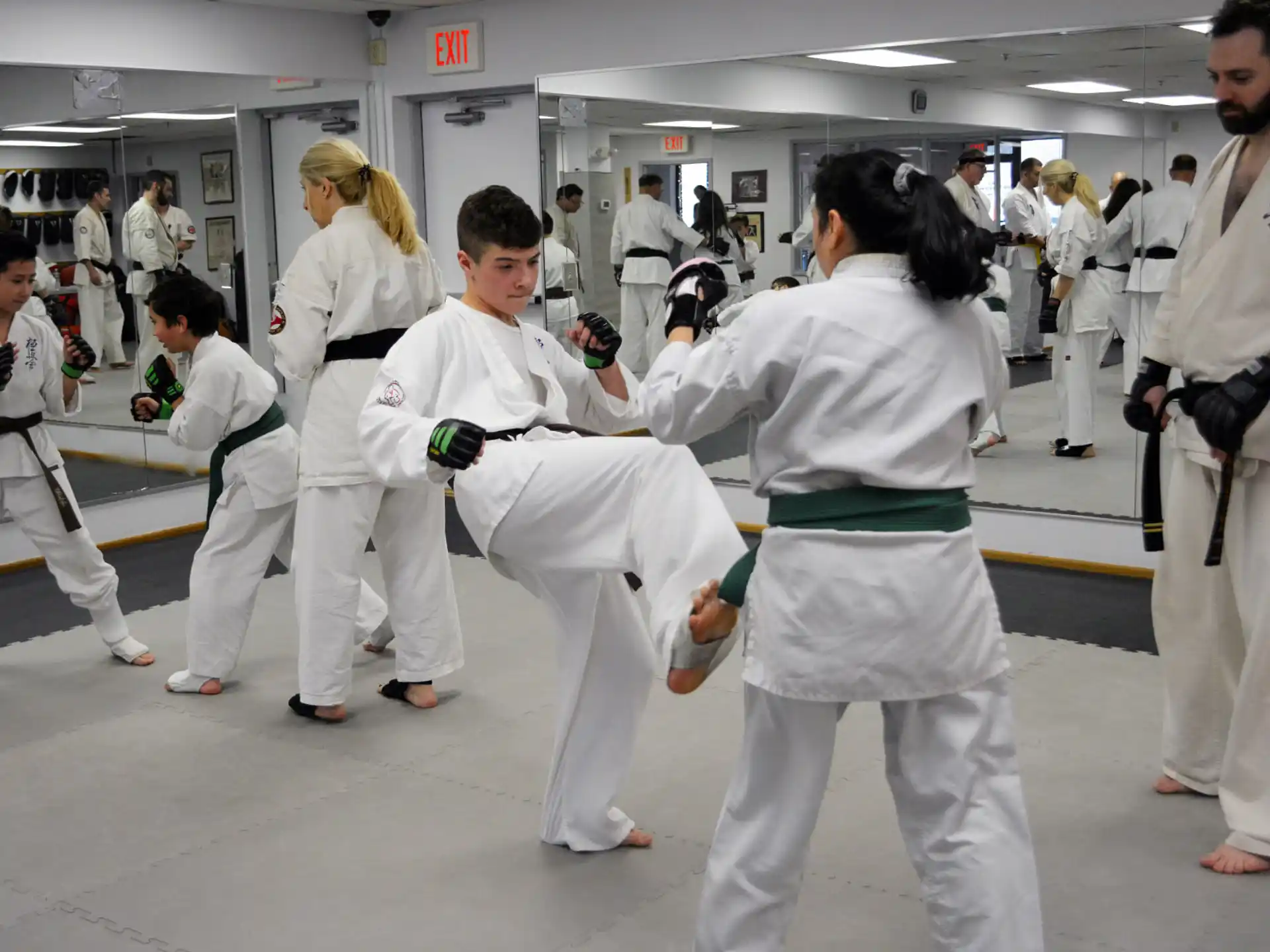 a group of people in white karate uniforms