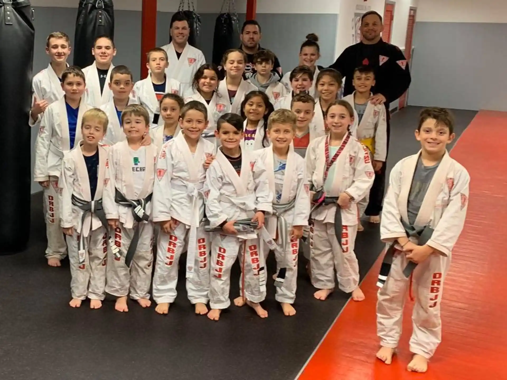 a group of children in karate uniforms