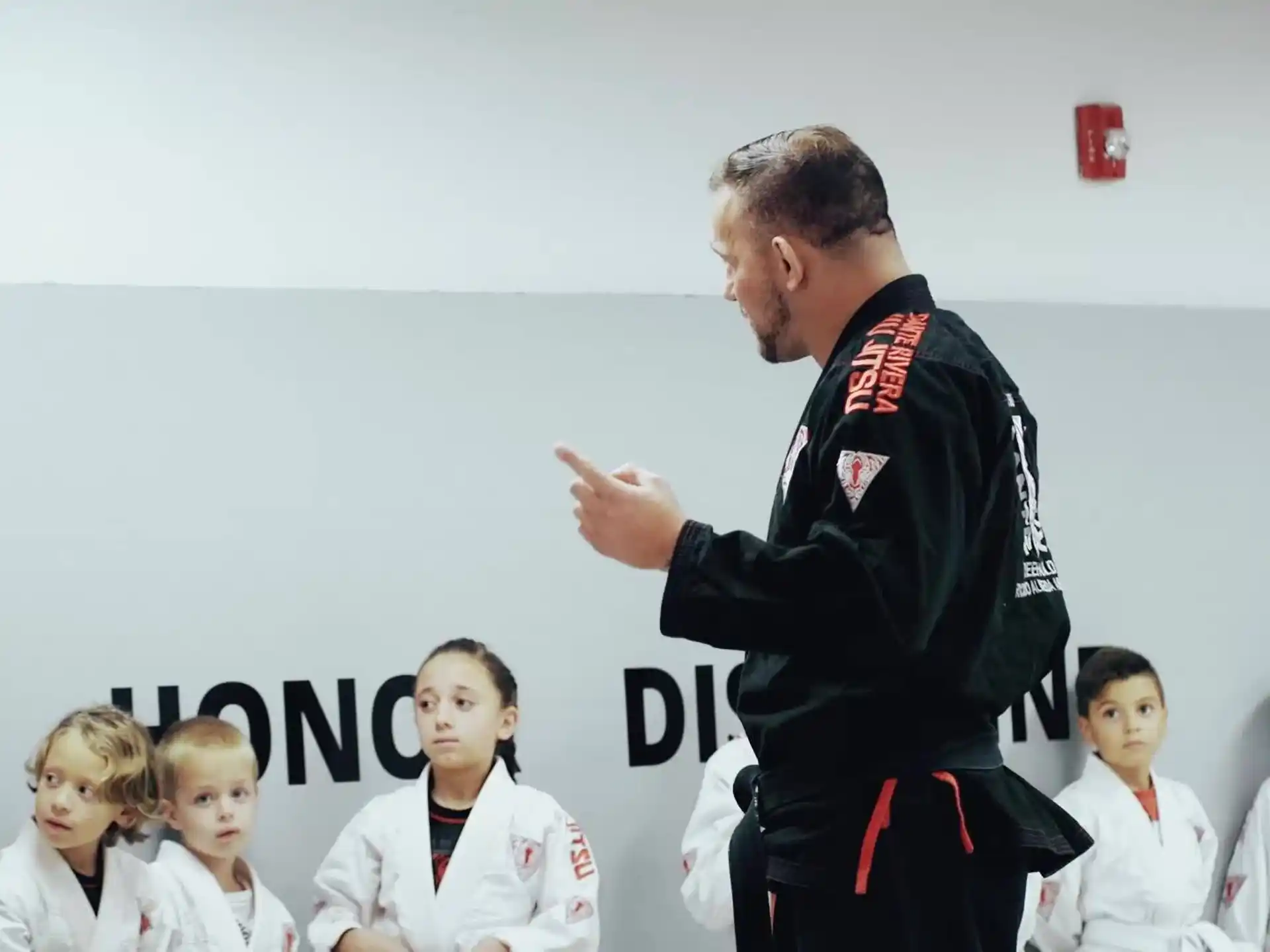 a person in a uniform standing in front of a group of children