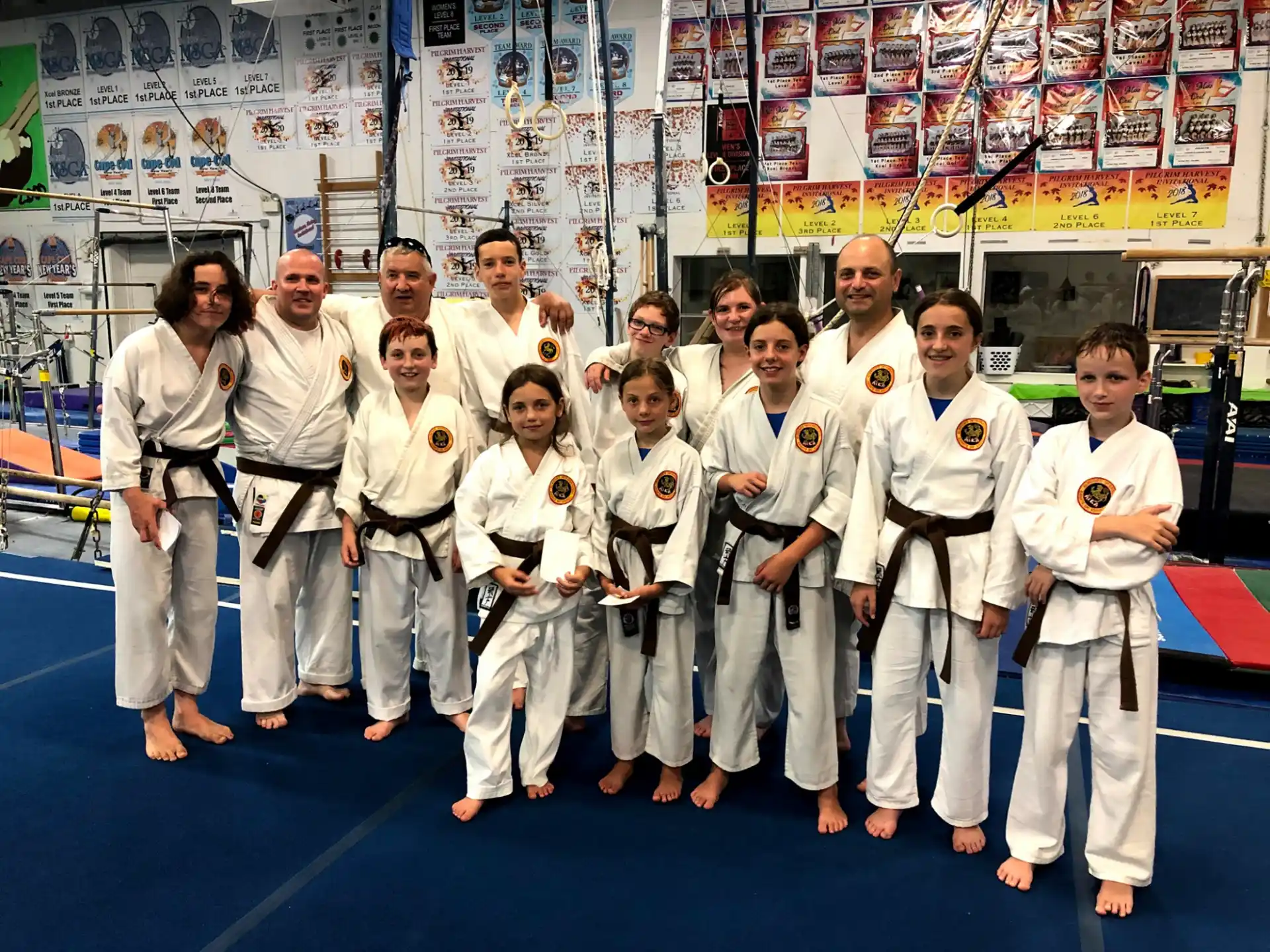 a group of people in white karate uniforms