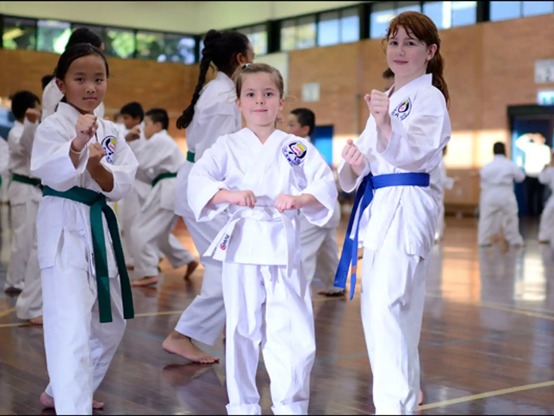 a group of girls in karate uniforms