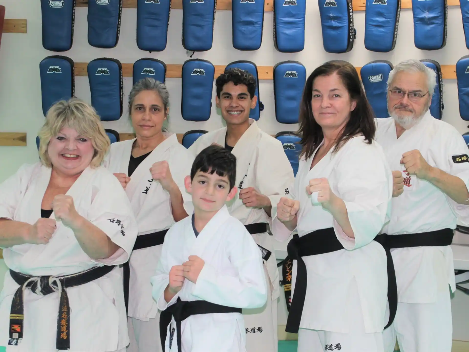 a group of people wearing white karate uniforms