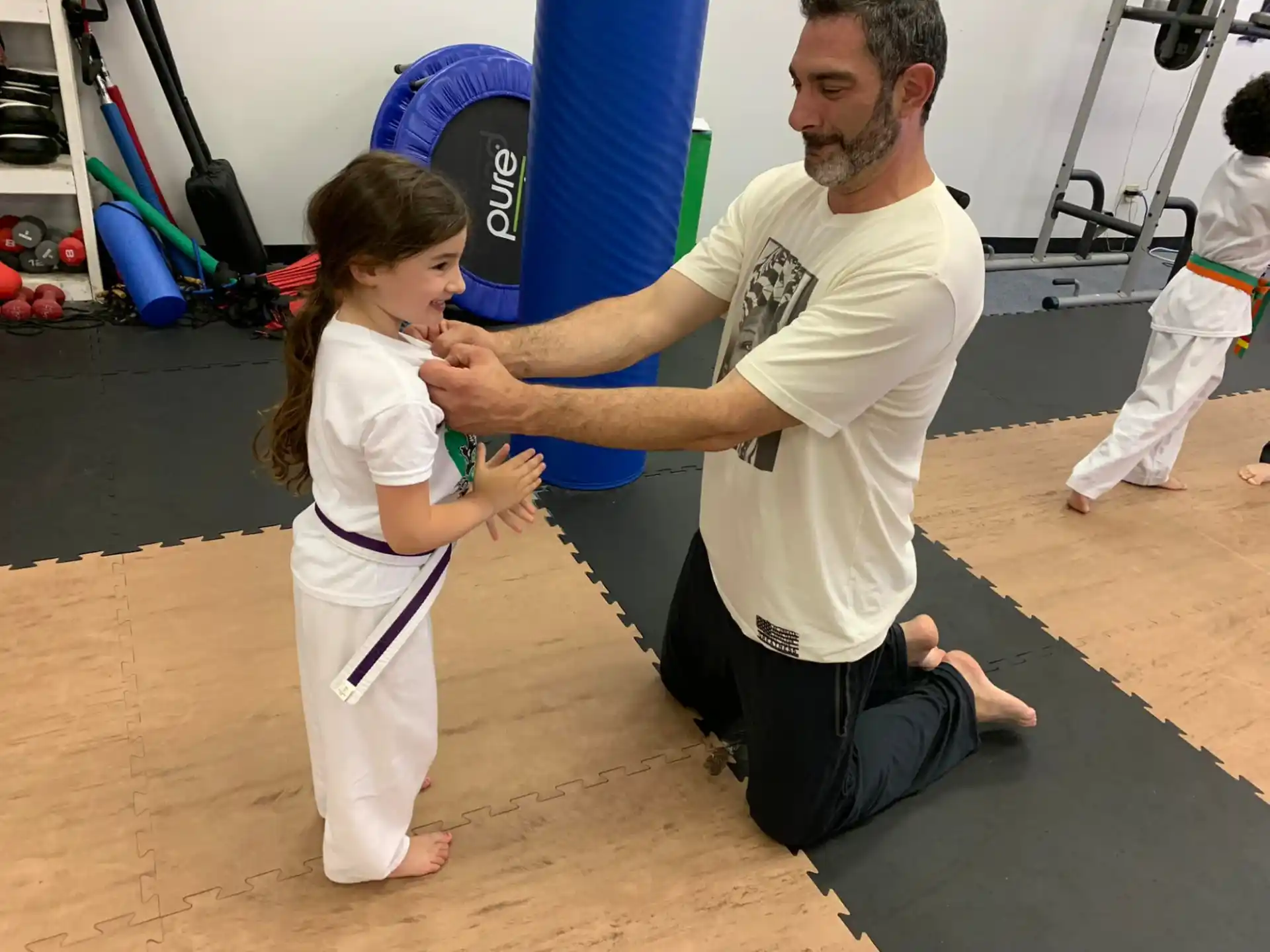 a man and a girl in a gym